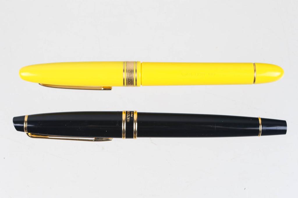 Waterman and Omas Extra Fountain Pens: First is a Waterman brand fountain pen with a black and gold aesthetic. Made in France. Second pen is Omas Extra, and made in Italy. Uses a yellow and gold aesthetic, with a twist off cap.