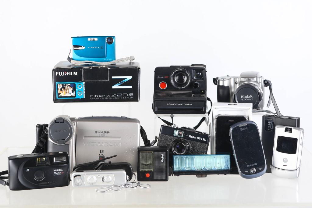 Camera and Movie Camera: includes a Sharp VL-E660 ViewCam, a Kodak x10 Zoom camera, a Polaroid camera, a Rollei 35LED camera, a Yashica profile camera, various phones, bags, tape recorders and accessories.