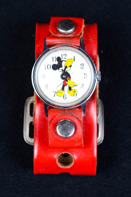 Vintage Mickey Mouse Watch: US Time Mickey Mouse wind up watch in a stainless case with original red strap. Walt Disney Productions. Not running.