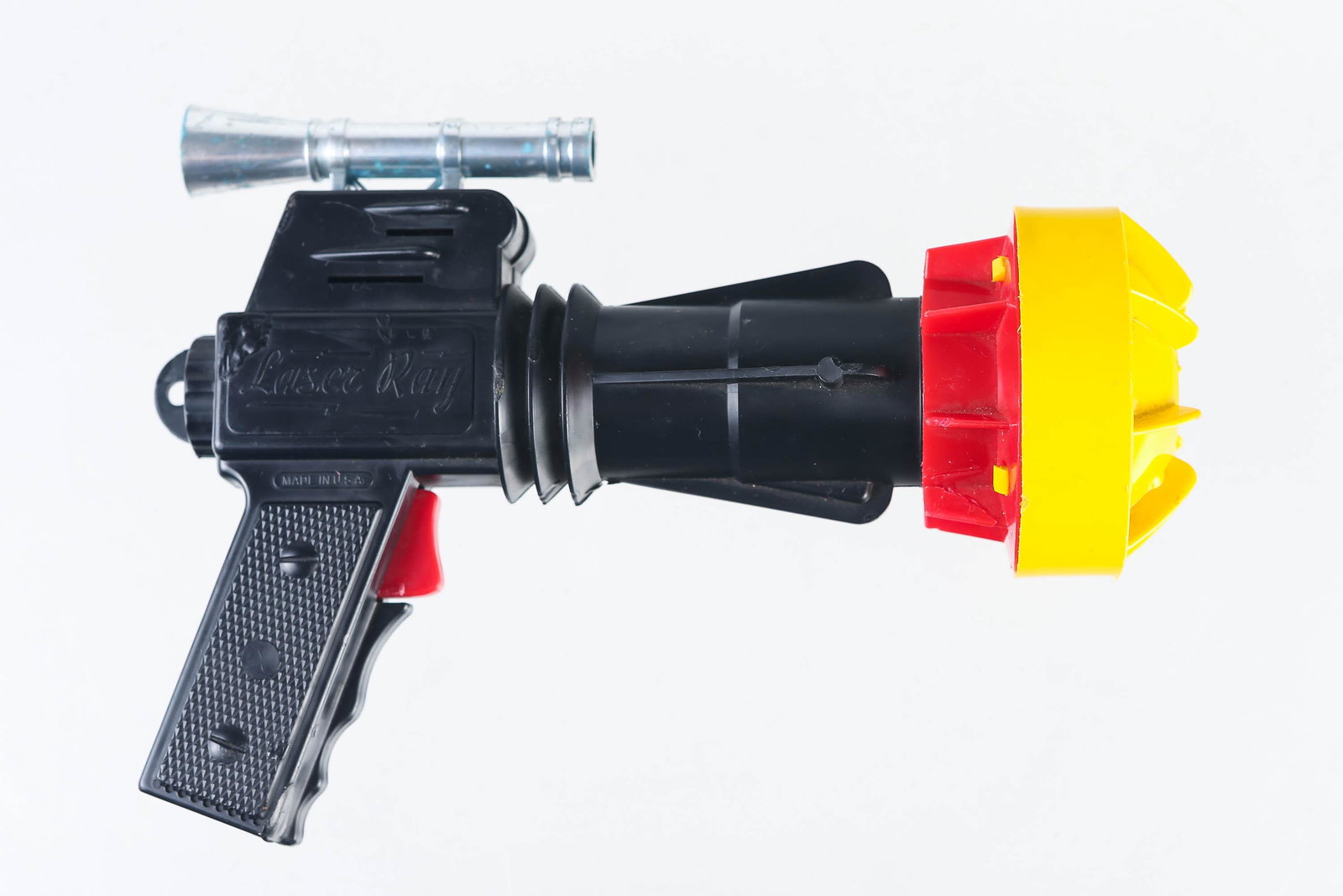 Laser Ray Plastic Space Gun Light: Toy gun has black plastic body with screw off barrel tip for battery installation (some repaired cracks in plastic). Toy made is USA, gun trigger appears to be the on switch for light. Measures 8" lon