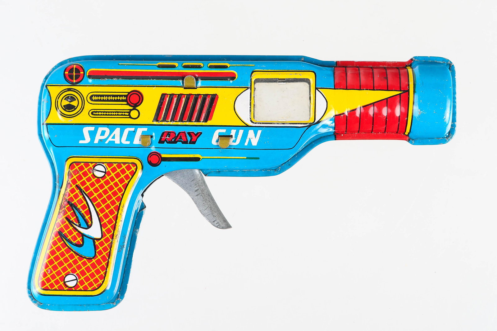 Tin Litho Space Ray Gun: Toy gun measures 6 1/2" long. Made in Japan with good graphics. Trigger makes noise and produces sparks inside which is viewed in plastic window.