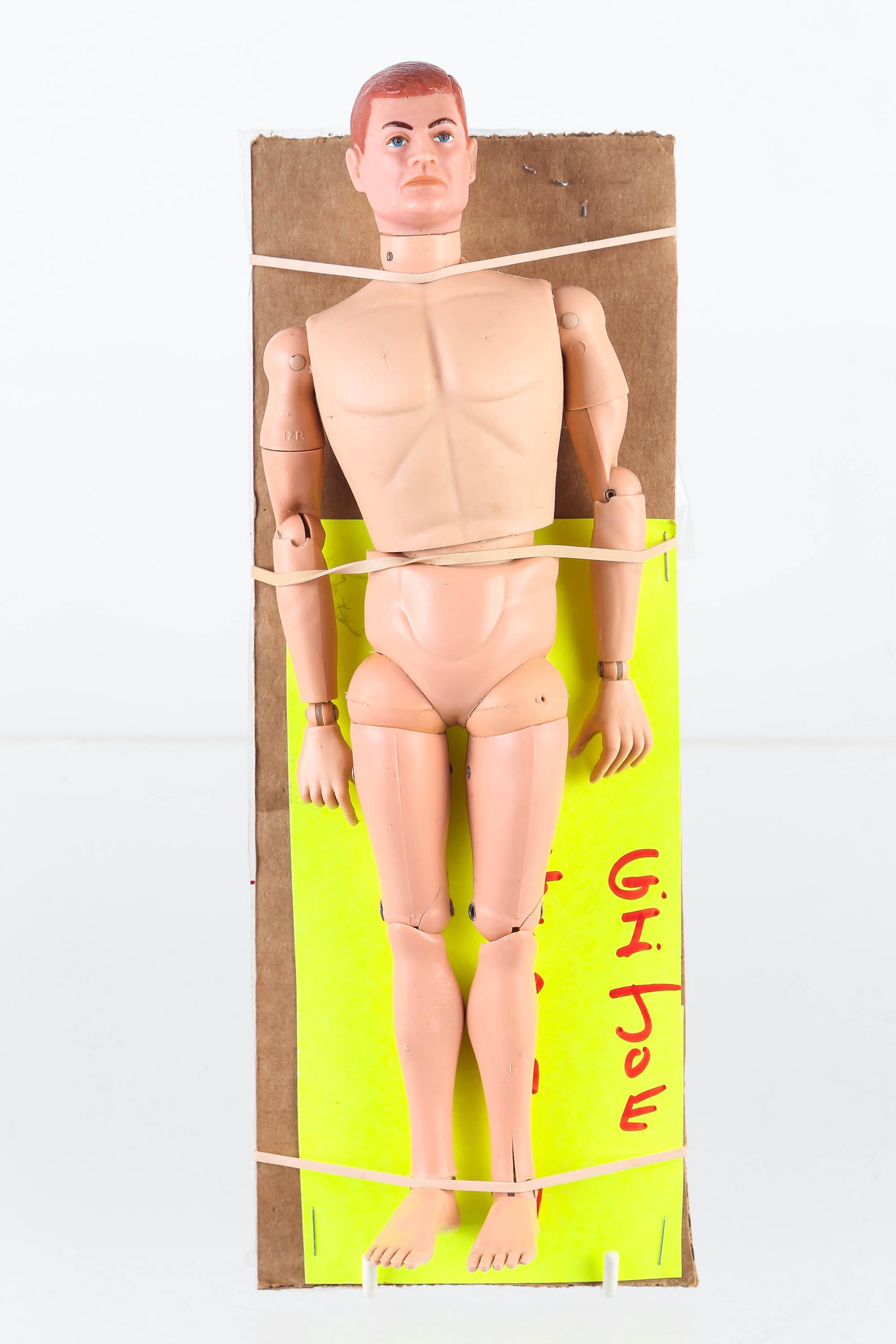 Hasbro G.I. Joe Action Figure with German Attire: Figure measures 11" high, with German coat and fur hat, body dated 1964 USA, and plastic body has some hair line cracks on both legs