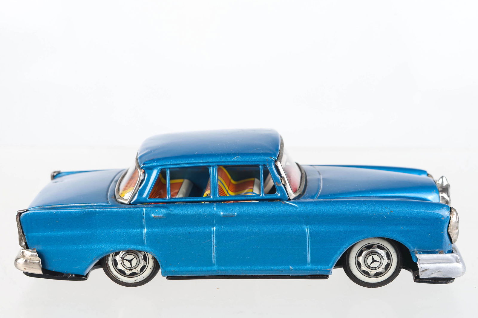 Japanese Friction Mercedes Benz: Car measures 8 1/4" long, bottom reads Cragstan, in working condition, with scratches on paint, and repainted front bumper. Circa 1950's