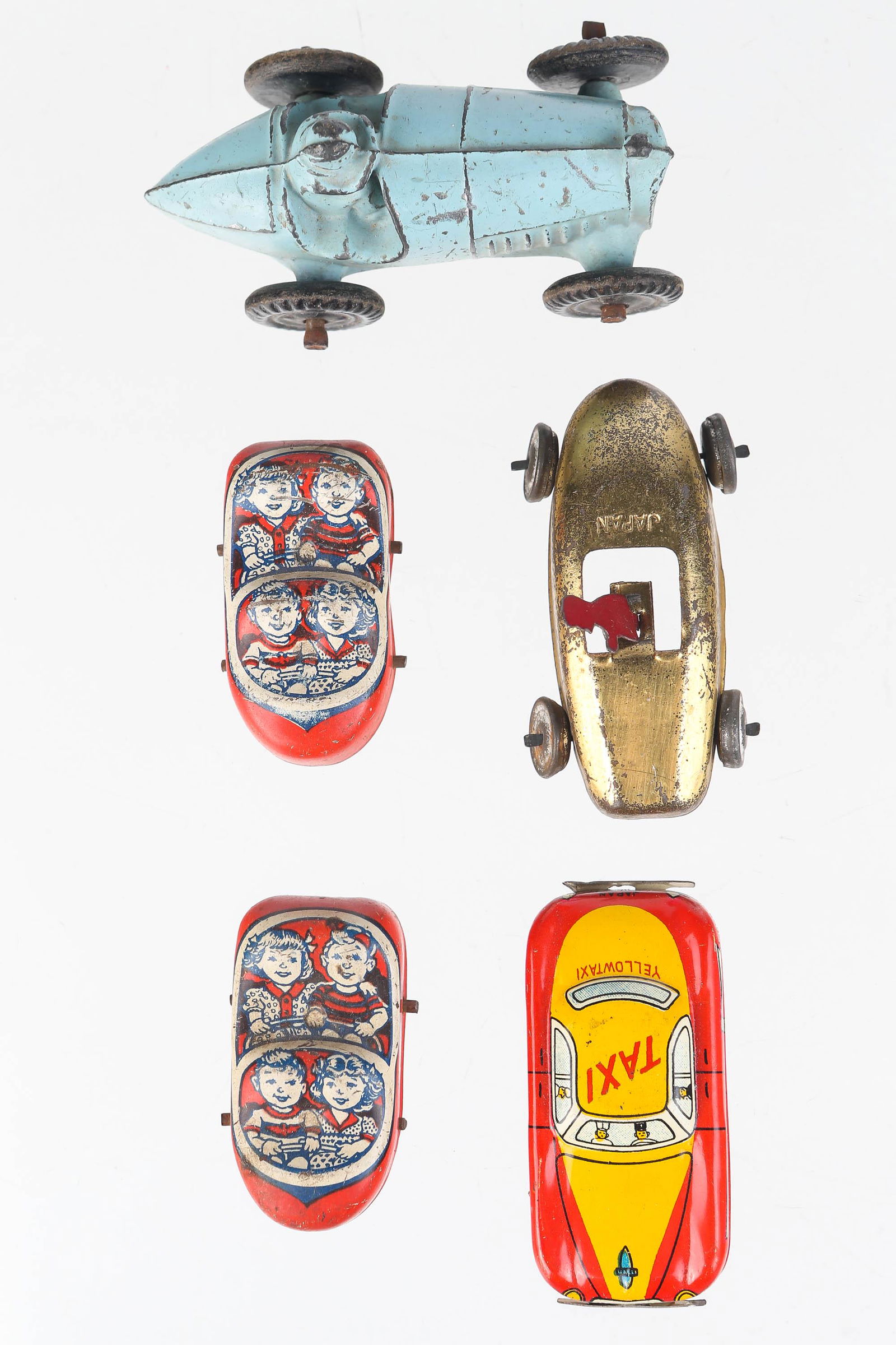 Blue Racer and 4 Roller Coaster Cars: Racer measures 3" long and is made of cast metal, and has wear consistent with age. Also includes 4 roller coaster cars made of tin; one in the form of a taxi, one in the form of a gold racer, and 2 m