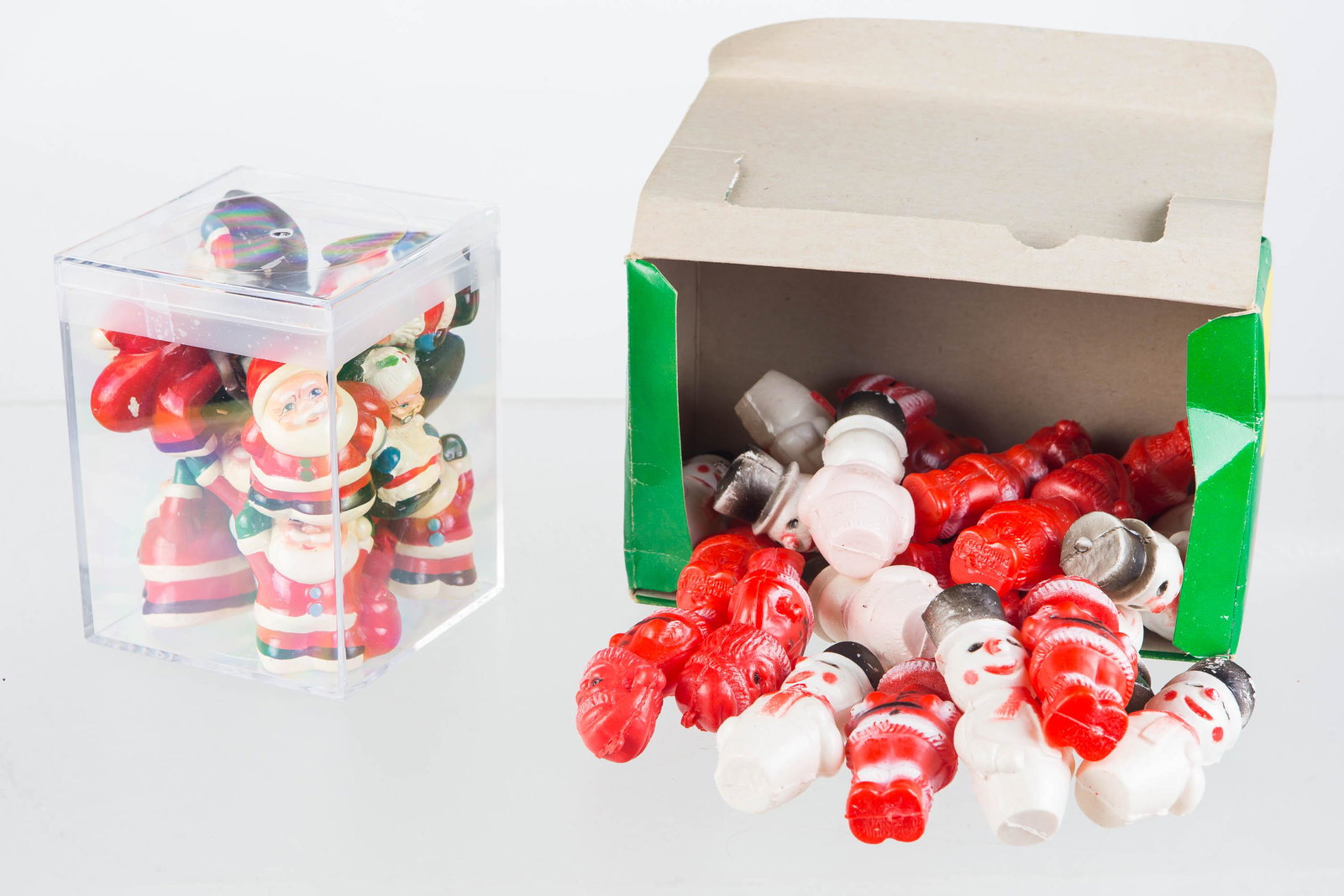 Santa Pencil Sharpeners & Containers: Approx. 13 pencil sharpeners including Santa and Mrs. Claus, measuring 2" high, features Santa in different poses, and some paint loss to some of the sharpeners circa 1970's. Also includes a box of Sa