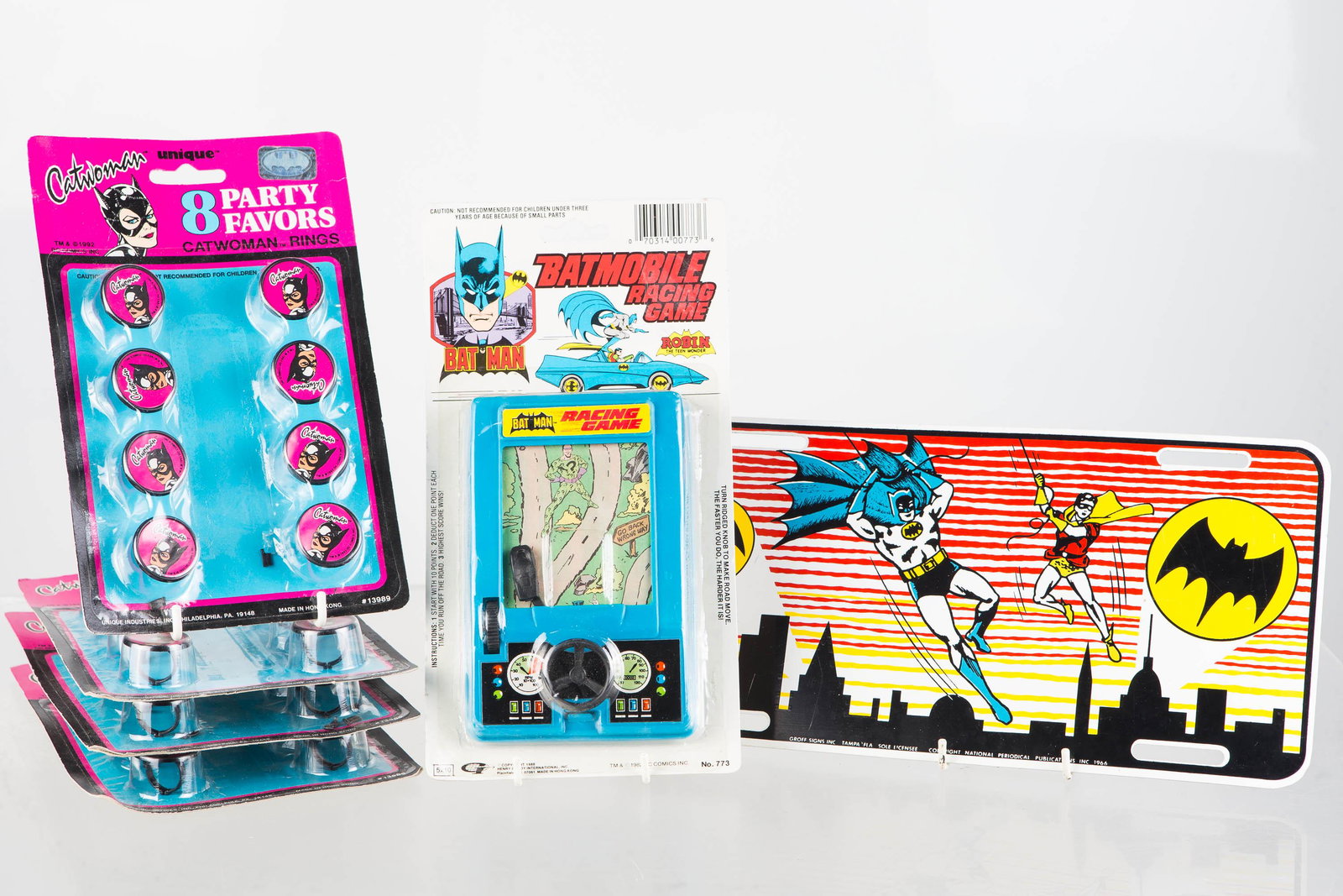 Batman Grouping with Racing Game: Lot includes Batman Racing game in original hang card packaging, and model #773 1988. 1966 Batman and Robin license plate with bat symbol graphic in background and very light scratching to front surfa