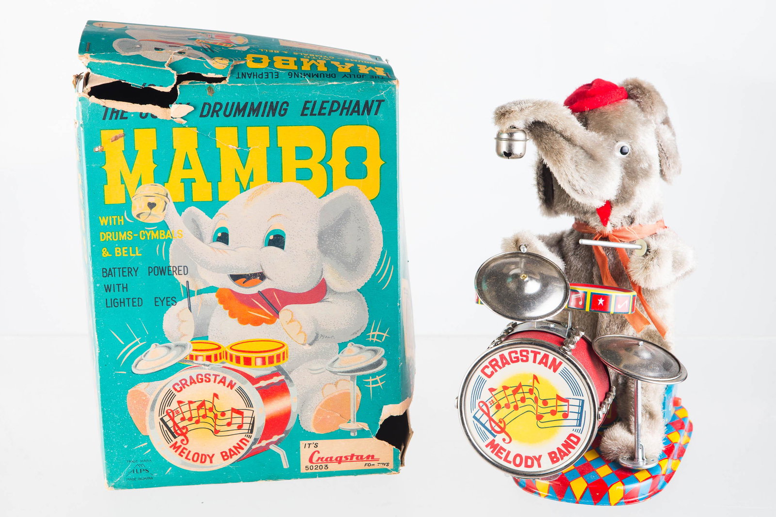 Mambo the Drumming Elephant, Battery Operated: Elephant measures 9" tall, made by Cragstan, model #50203, comes in original box (wear to box), made in Japan, tin litho base and drum, and graphics are nice with minor signs of use