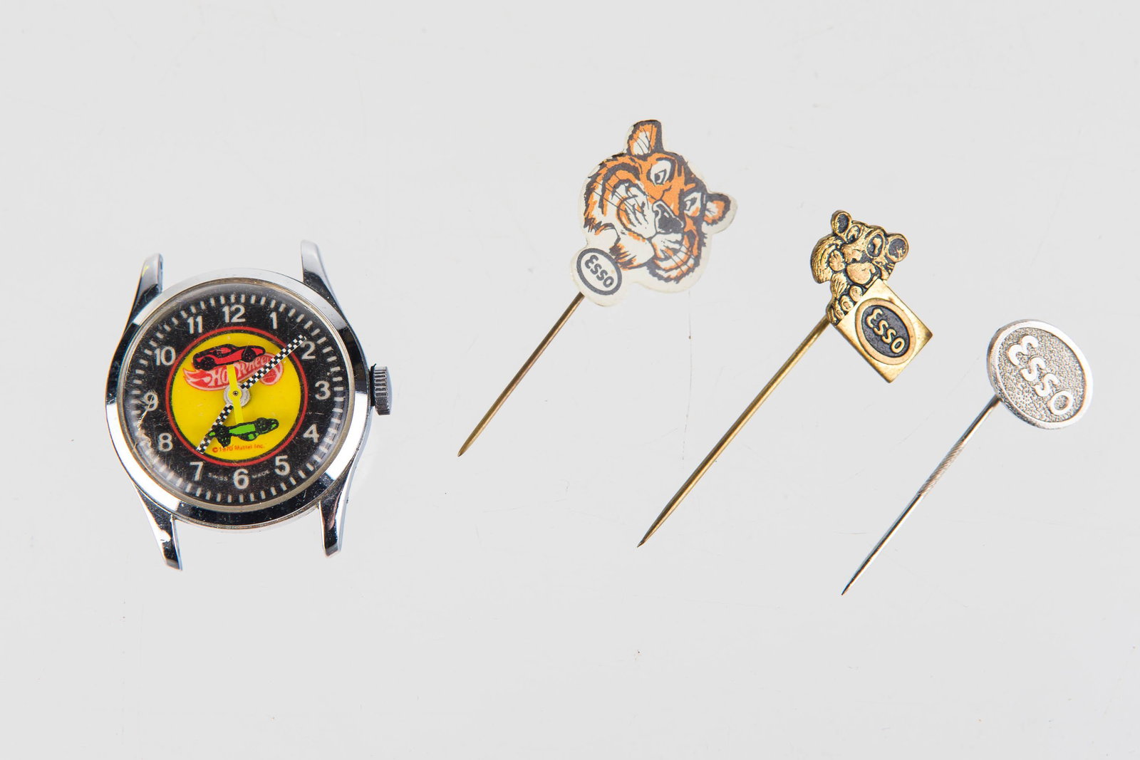 Hot Wheels Watch & 3 Esso Stick Pins: Watch is wind-up, made in 1970, no band, swiss made, and works. Stick pins come in three variations as premiums for Esso gas.