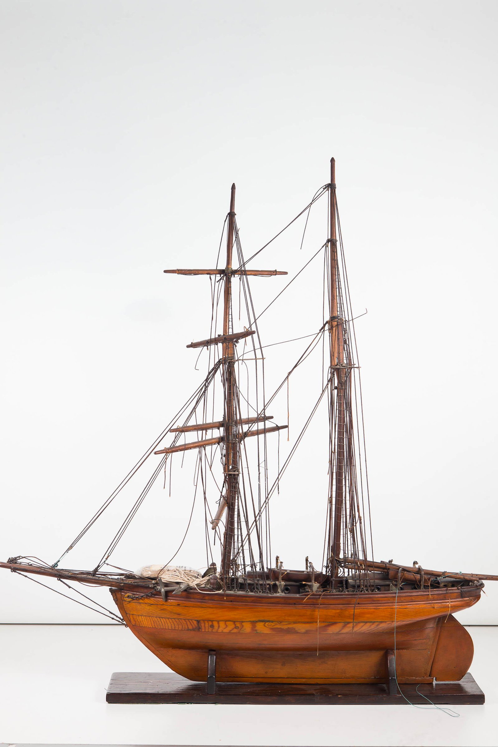 Tall Ship Wood Model: Approximately 35"H from base to top of mast and 33"L stem to stern. Constructed of wood with twine ladders and mast ropes. Item appears to be complete, but has no sails. Original rigging and bag with