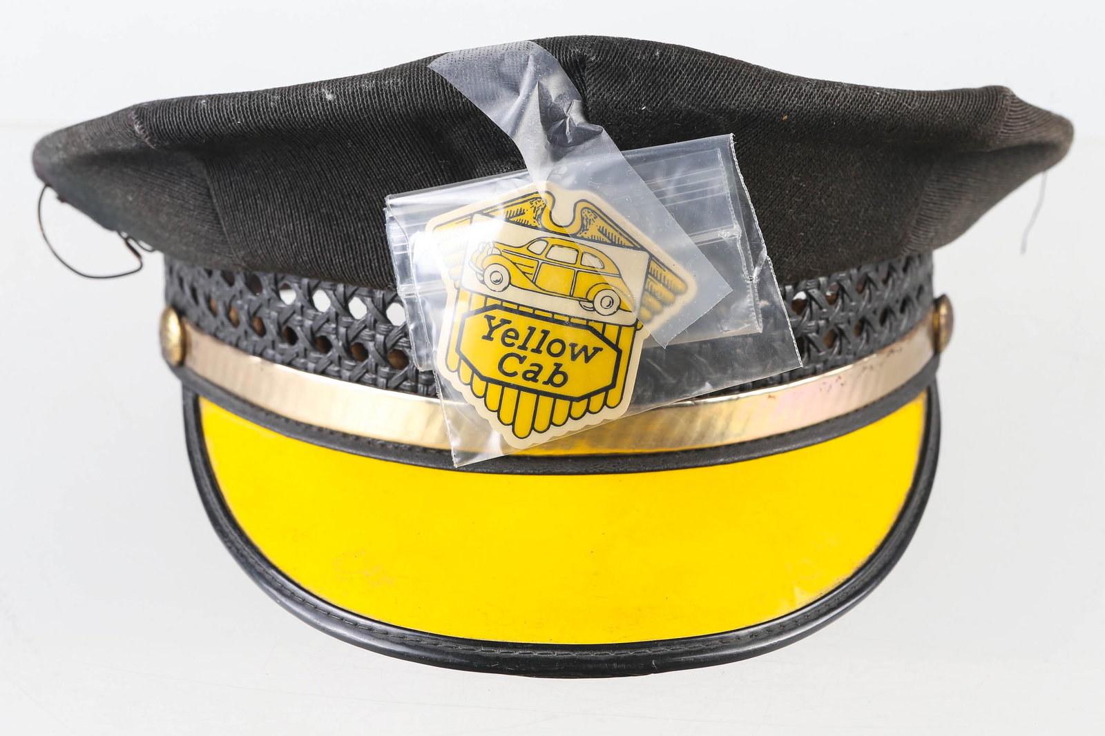 Vintage Yellow Cab Hat: Cloth hat with hard yellow brim. Size 7.25. Produced by The Midwest Uniform Company. Badge is loose. Cap shows common wear.