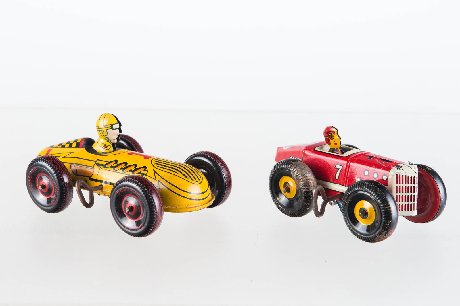 Marx Wind UP Race Cars: Larger approximately 6.5"L. yellow wind up tin litho toy with clicker mechanism. Fully functional. Second item is red tin litho wind up. Fully functional. Both toys have tin litho wheels, and Marx log
