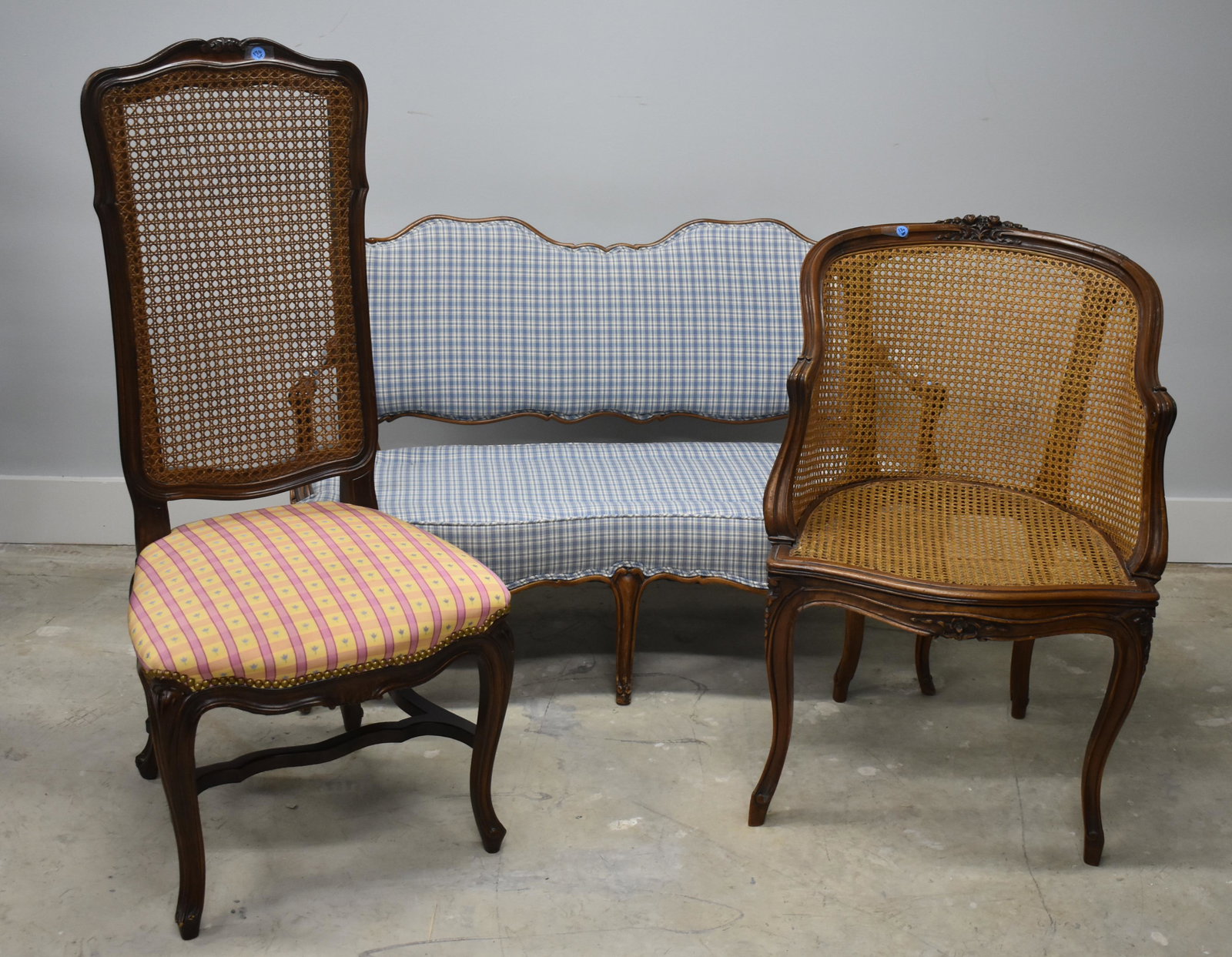Mixed Settee and Chairs: Lot includes an upholstered settee (48" across), three cane back chairs (one marked Escalier De Cristal Paris), and a foot stool.