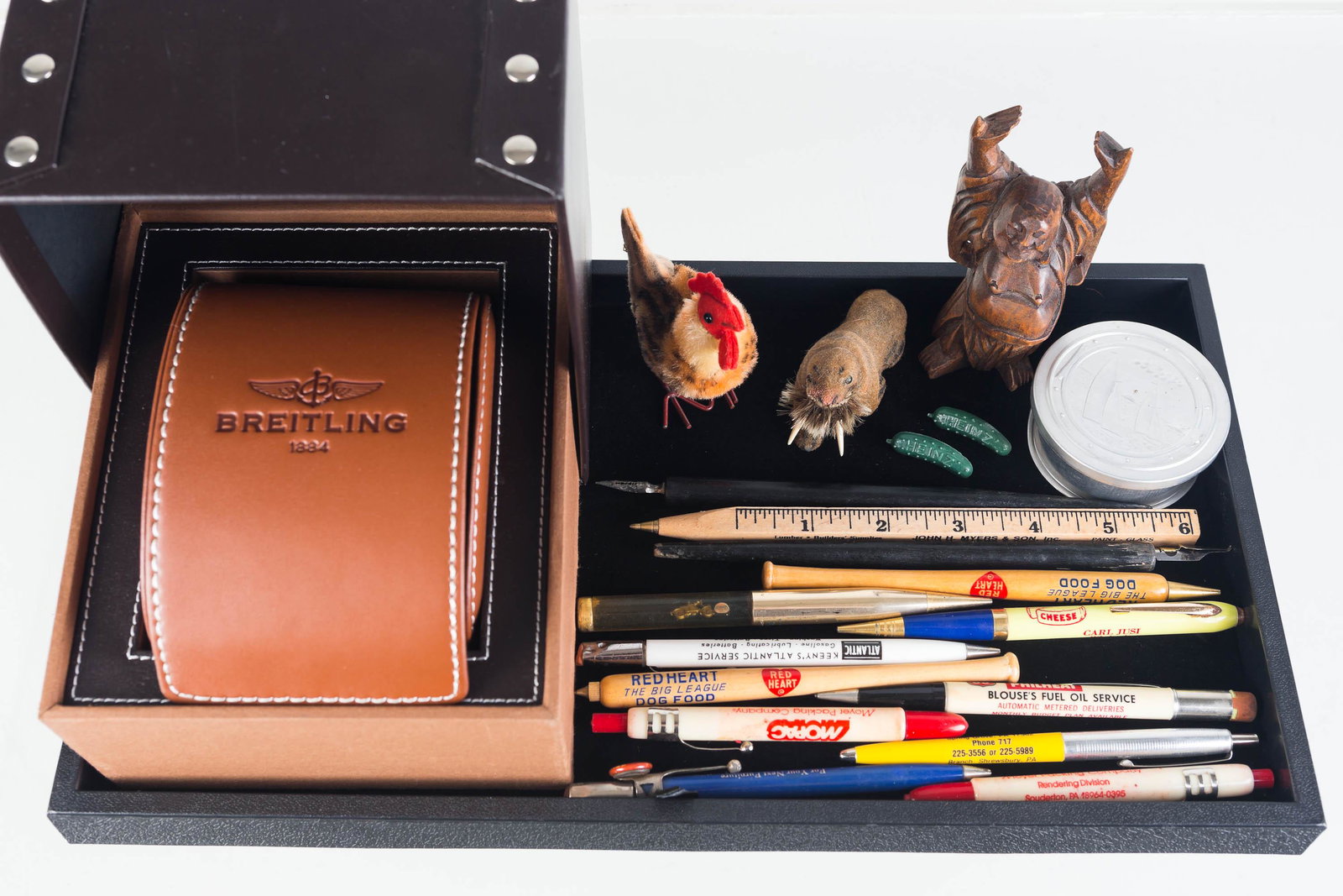Advertising Pens, Pencils, and Breitling Matchbox: Lot includes two advertising bullet pen markers, two Red Heart dog food baseball pins, slider pen with motorcycle, other advertising pens and pencils, two small German animals, a Buddha, pickle pins, 