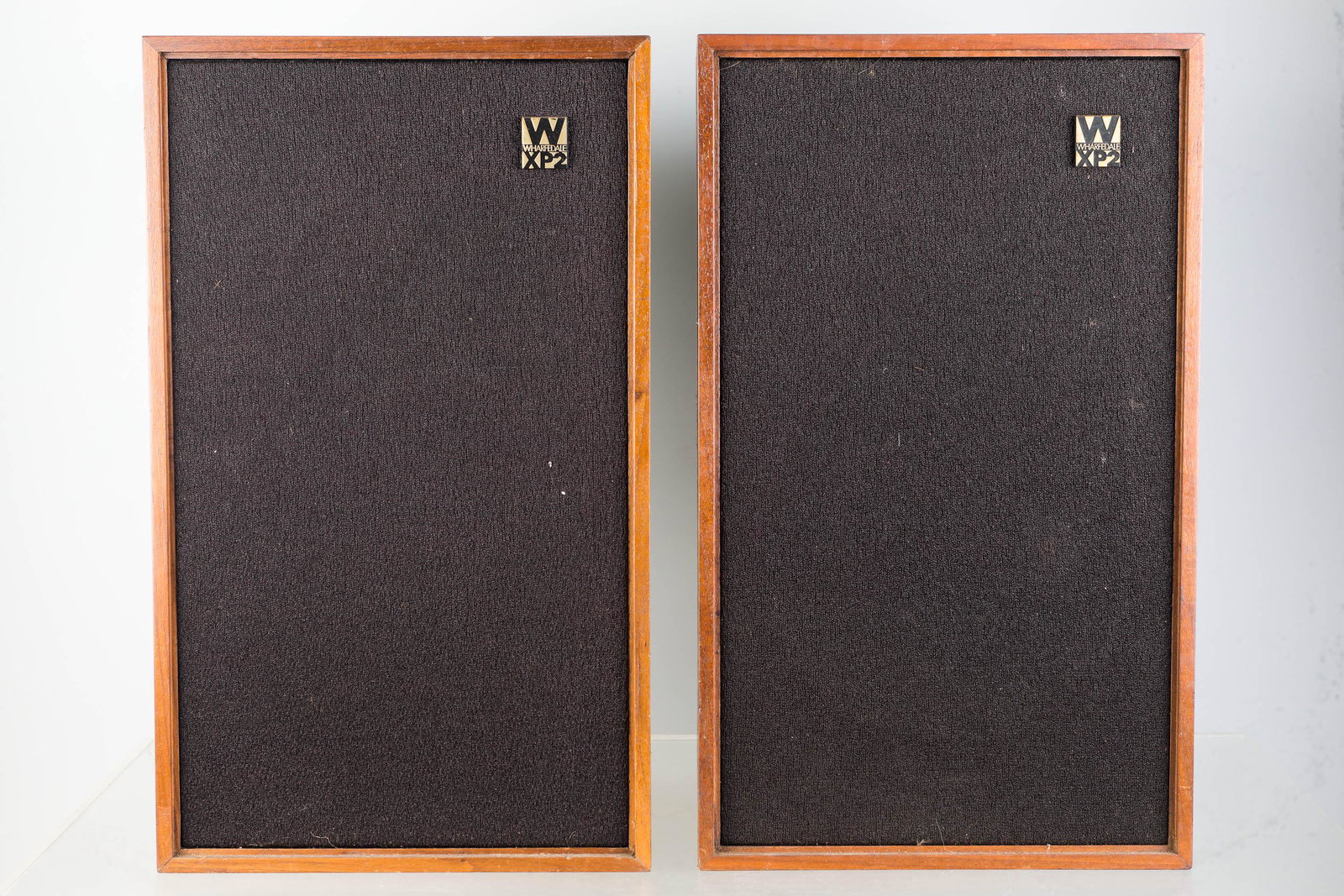 Wharfedale XP2 Vintage Stereo Speakers: Approximately 16"H. Mahogany veneer bodies. Good grills. Original Wharfedale Shelton XP2 metal tags on back. Produced in England.