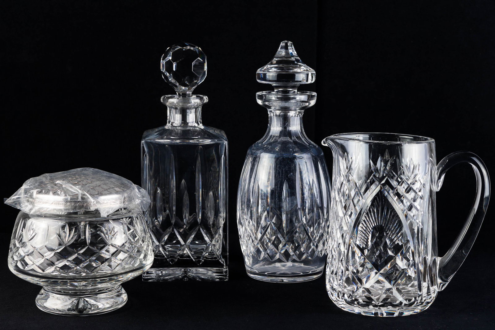 Quality Crystal Grouping: Lot includes two decanters (10.5"H), a water pitcher, and a Thomas Webb crystal jar with mesh lid (in box)