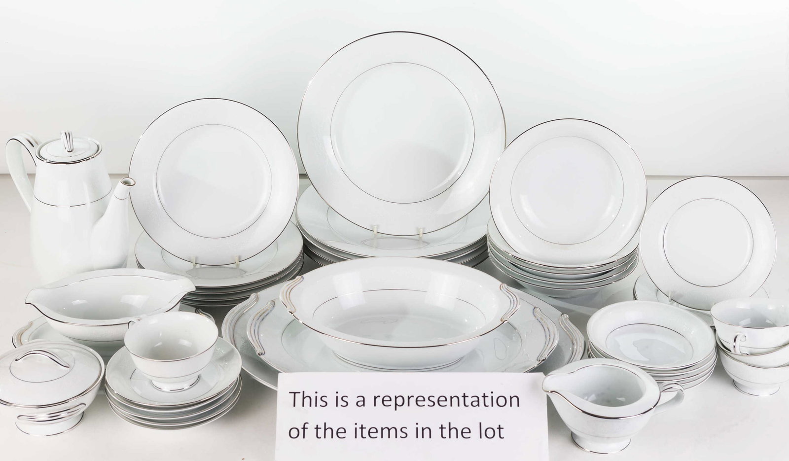 Noritake White Hall Dinnerware Service: Lot includes 14 (10.5") dinner plates, 14 bread and butter plates, 11 soup bowls, 12 fruit bowls, 14 cups and saucers, 14 salad plates, creamer and sugar, teapot, gravy on tray, 2 open vegetable bowls