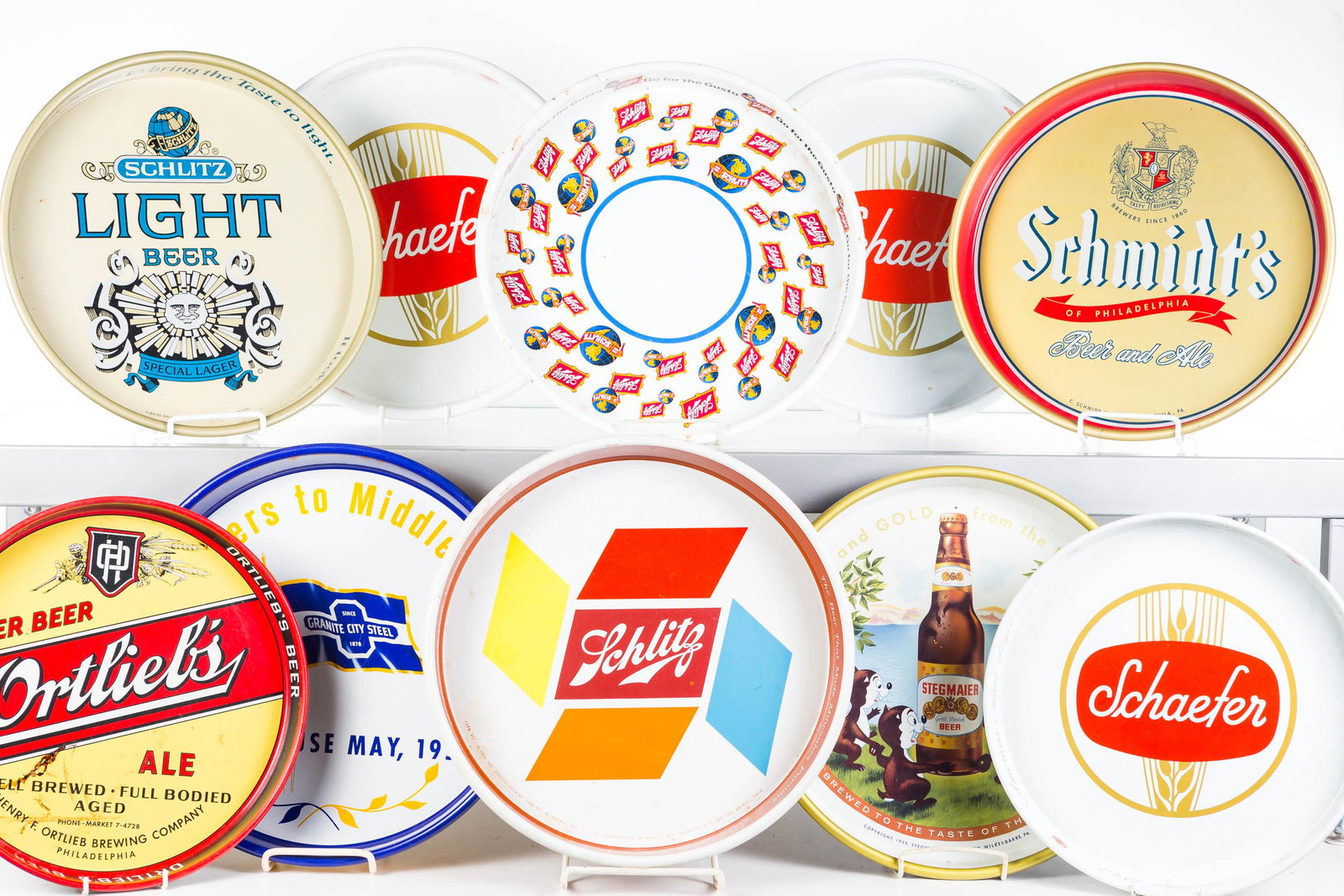 Advertising Beer Trays: Lot includes Ortleibs, various Schaefer, Schlitz, Stegmaier, and a 1959 Steel Makers advertising beer tray. Some show common wear. 8 total pieces.