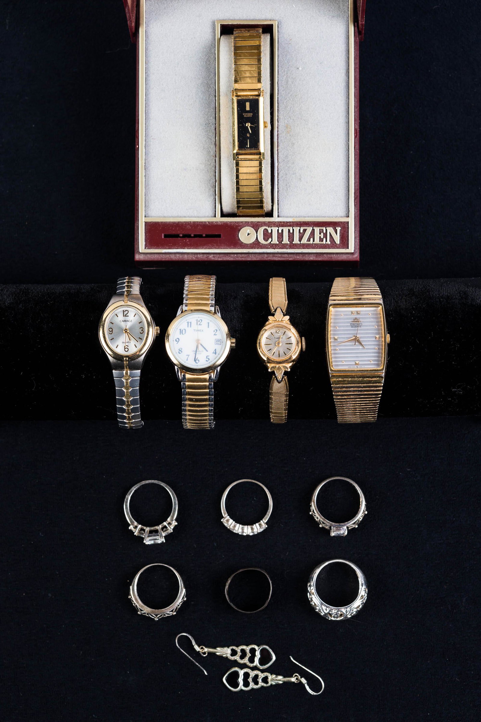 Ladies Watches and Sterling Jewelry: Lot includes Citizen Quartz in box, gold tone Seiko Quartz, a Carriage Quartz, and two ladies' Timex, three sterling rings, a pair of sterling earrings, and a pair of non-sterling rings
