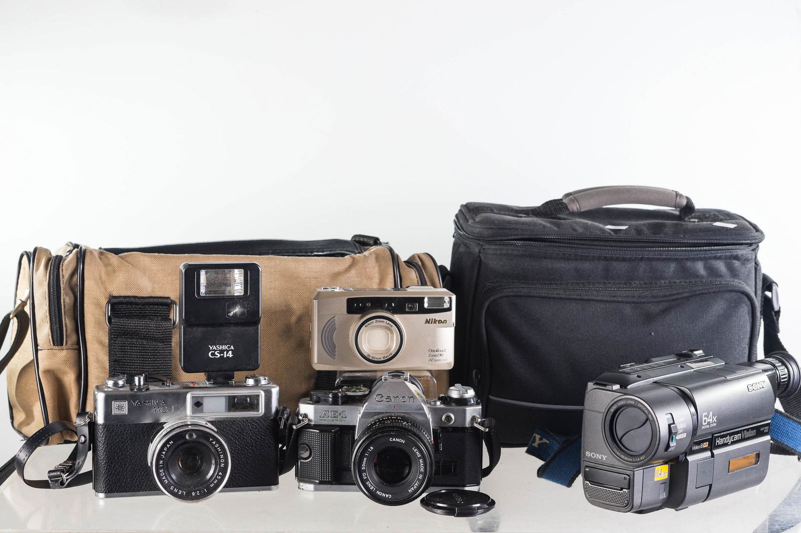 35mm Cameras and Recorder: Lot includes Canon AE-1 camera, Yashica MG-1 camera, Nikon One Touch Zoom 90, and a Sony 64X Video 8 SR handycam