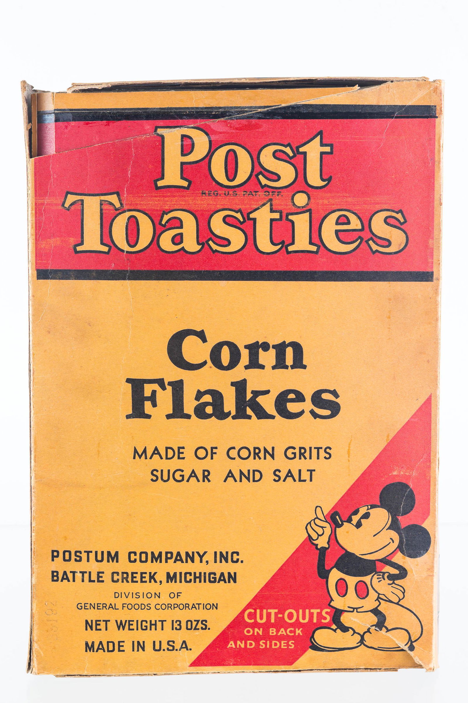 Post Toasties Mickey Mouse Cornflakes Box: Approximately 11"H. Mickey Mouse advertising and cutout on back and sides. Dated 1935, marked Walt Disney. Top and bottom side flaps are cut. Box has slice near top front, otherwise complete.