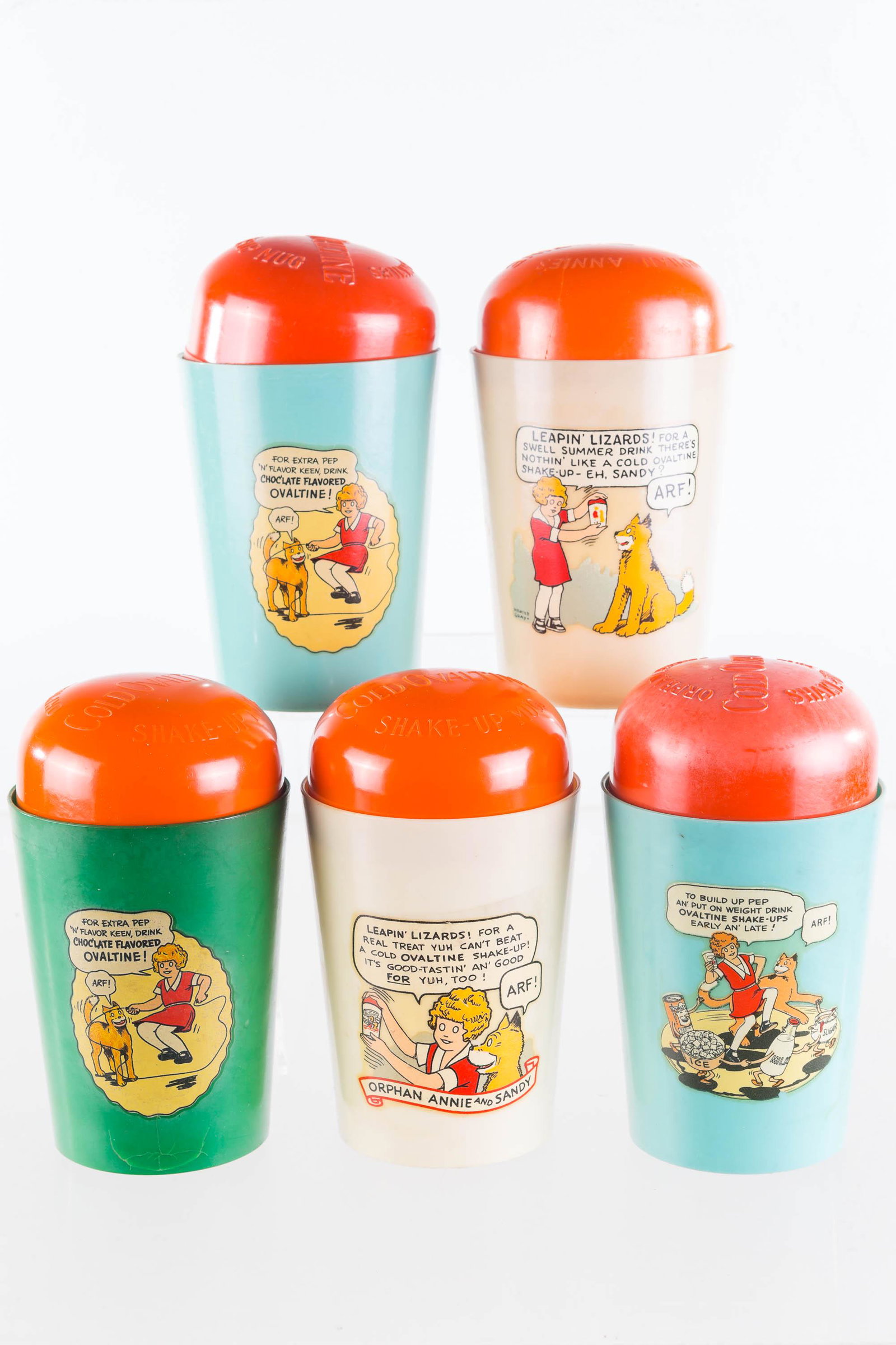 Orphan Annie Ovaltine Shake Up Mugs: Lot includes five Beetleware Ovaltine Shake Up mugs, all with Orphan Annie graphics. Graphics are good, one mug has tight hairline at bottom