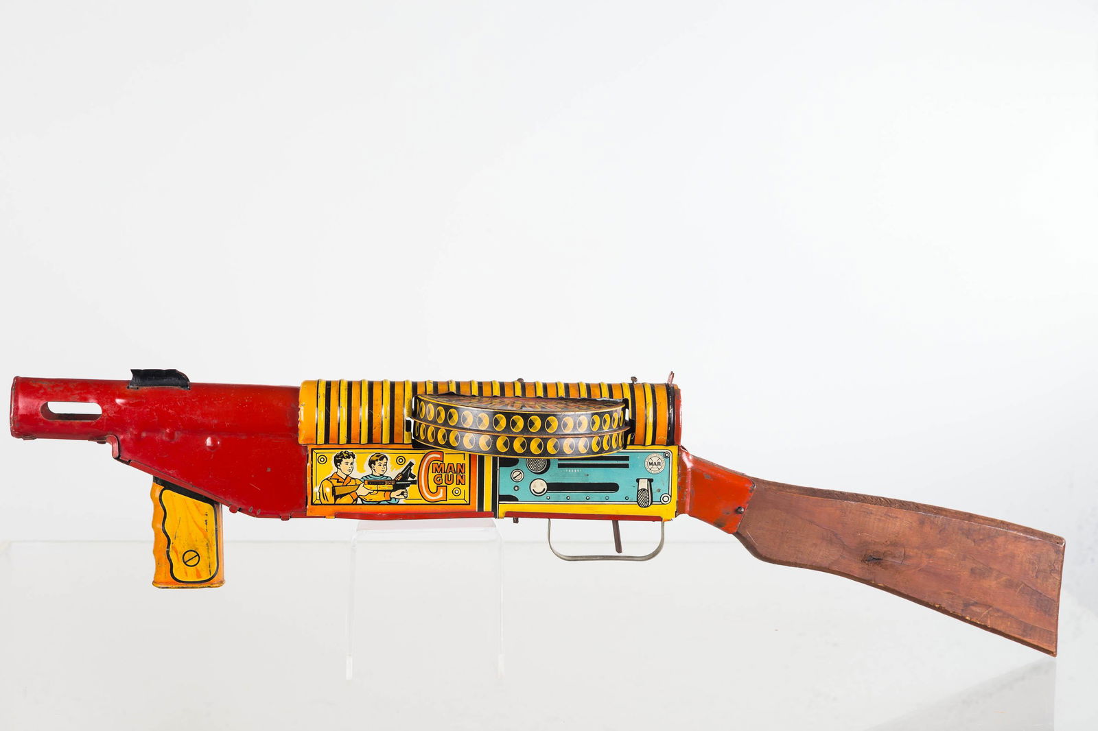 Marx G-Man Sparkling Double Action Gun: Good lithography with minor scuffs. Wooden handle. Caddy rotates when firing. Minor dent at opening of barrel. No longer sparks but spark wheel is present. Toy.