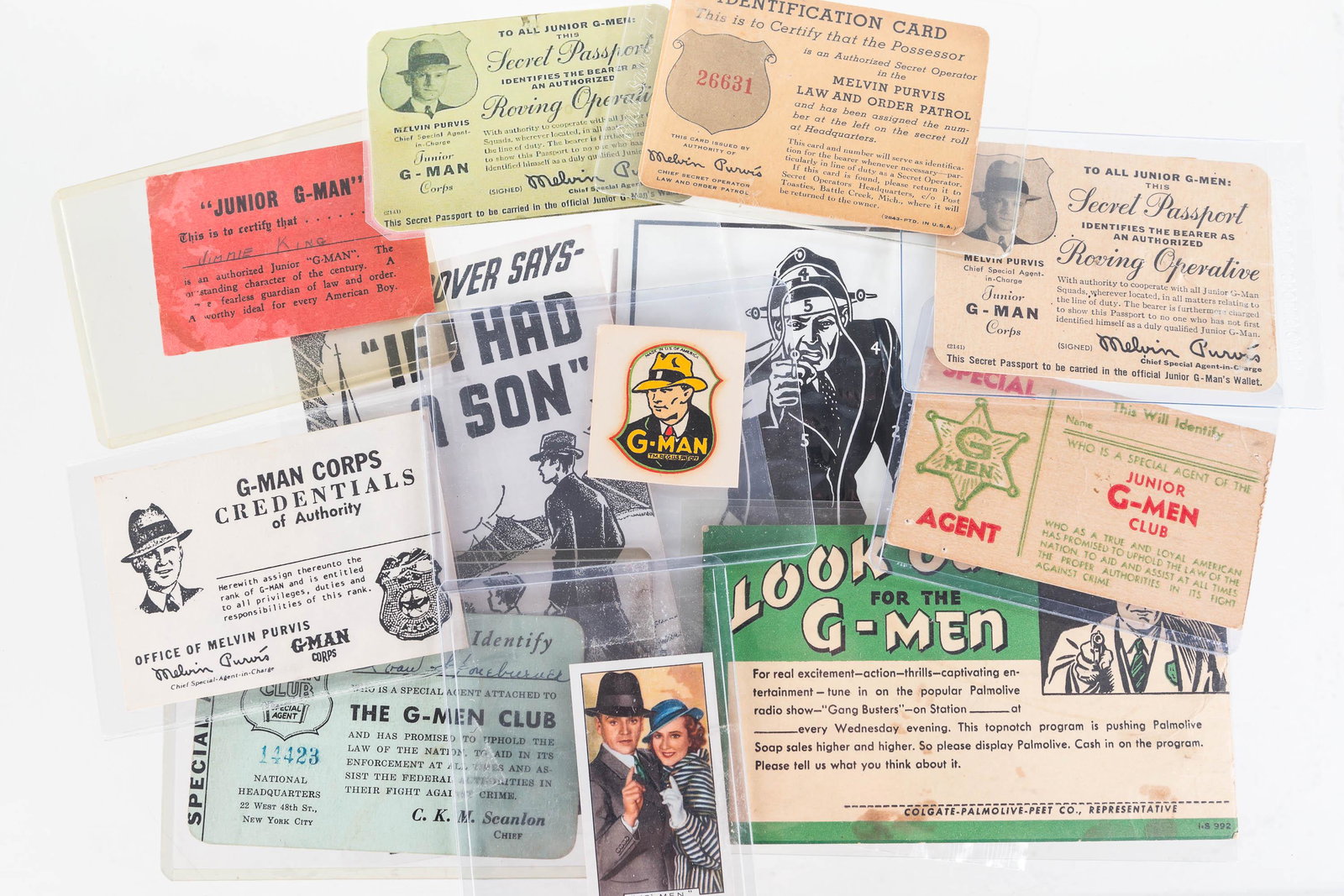 G-Man Ephemera Grouping: Lot includes 7 various G-Man and G-Men club and identification cards, a G-Man decal for a pistol, a G-Man miniature film card, G-Man training target, and two other pieces of G-Man ephemera.