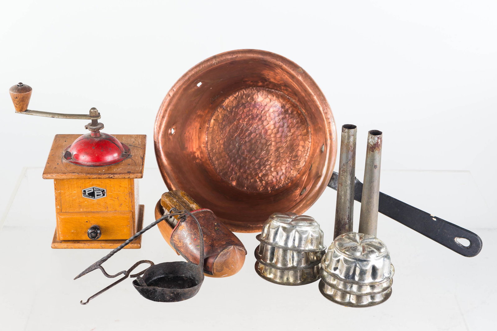 Vintage Coffee Grinder and Kitchenware: Lot includes a Pacciaio coffee grinder, copper kettle (missing one handle), six vintage molds, exterior of a betty lamp, and miscellaneous items