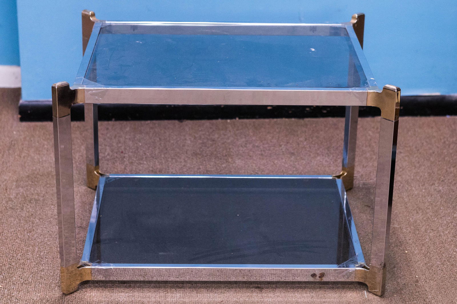 Post Modern Chrome and Glass Coffee Table: Approximately 21"H x 31"W x 24"D. Constructed of chrome and brass body, with glass inset top and base. No makers mark found. Early 1970s