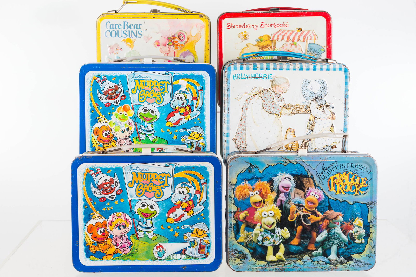Muppets, Care Bears, and Other Lunch Boxes: Tin lunch boxes include 2 Muppet Babies lunch boxes, Care Bears lunch box (1985), Strawberry Shortcake lunch box (1981), Fraggle Rock (1984), and Holly Hobbie lunch box (1979). All show common wear