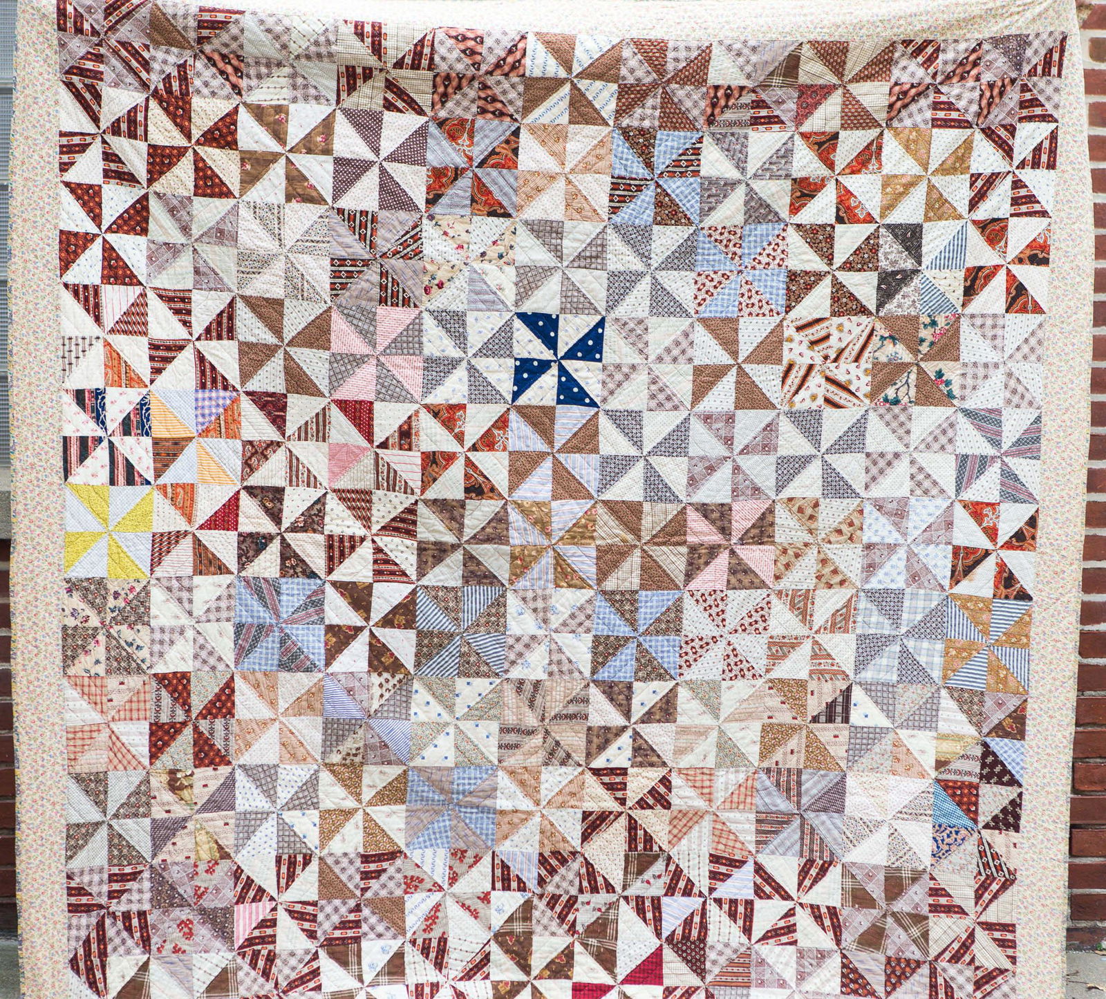 Vintage York Co. Pinwheel Quilt, 19th C: Approximately 83"L x 78"W. Hand stitched. 19th C pinwheel fabrics, and feed sack border and backing. Clean, with one small stain but no other visible damage. From the collection of quilting author Joa