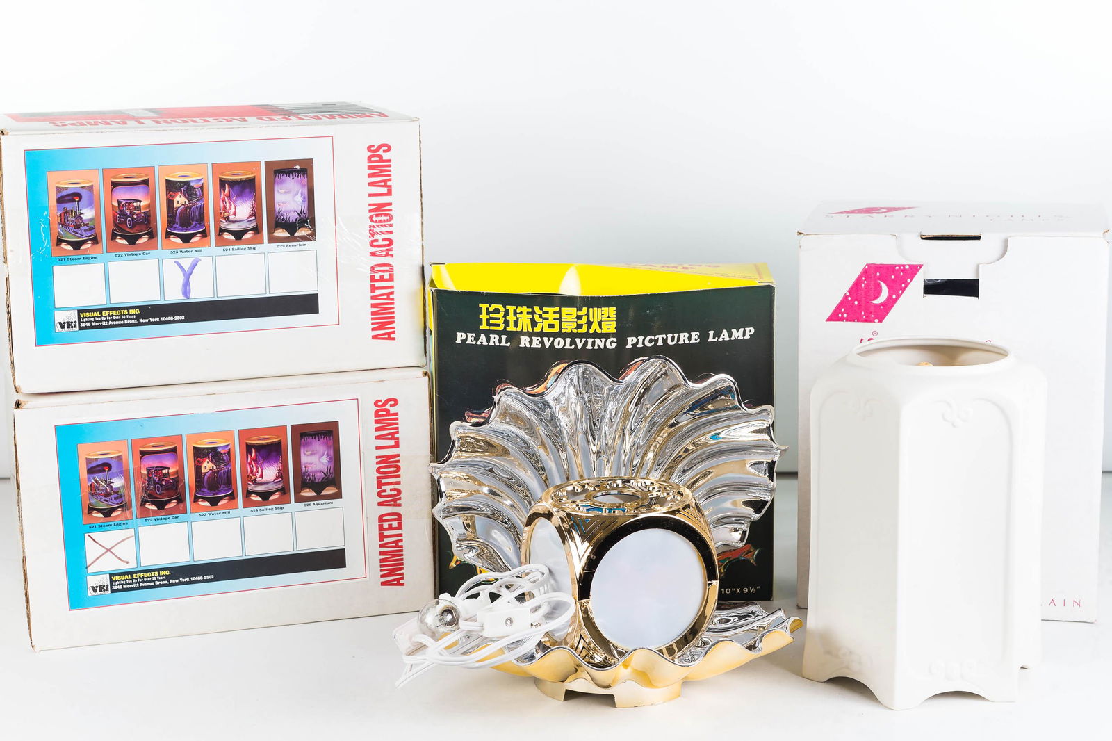 Motion Lamps NIB: Lot includes a train and a water mill by Animated Action Lamps, a cow over the moon motion lamp by Starry Nights, a pearl revolving picture lamp with tropical fish. All NIB.