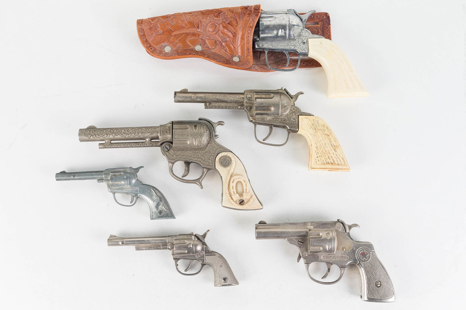 Hubley and Other Vintage Cap Pistols: Lot includes Hubley cap pistol, a Pony Boy, a Red Ranger, small Hubley Tex, a Trooper (not functioning). Pistols function to various degrees.