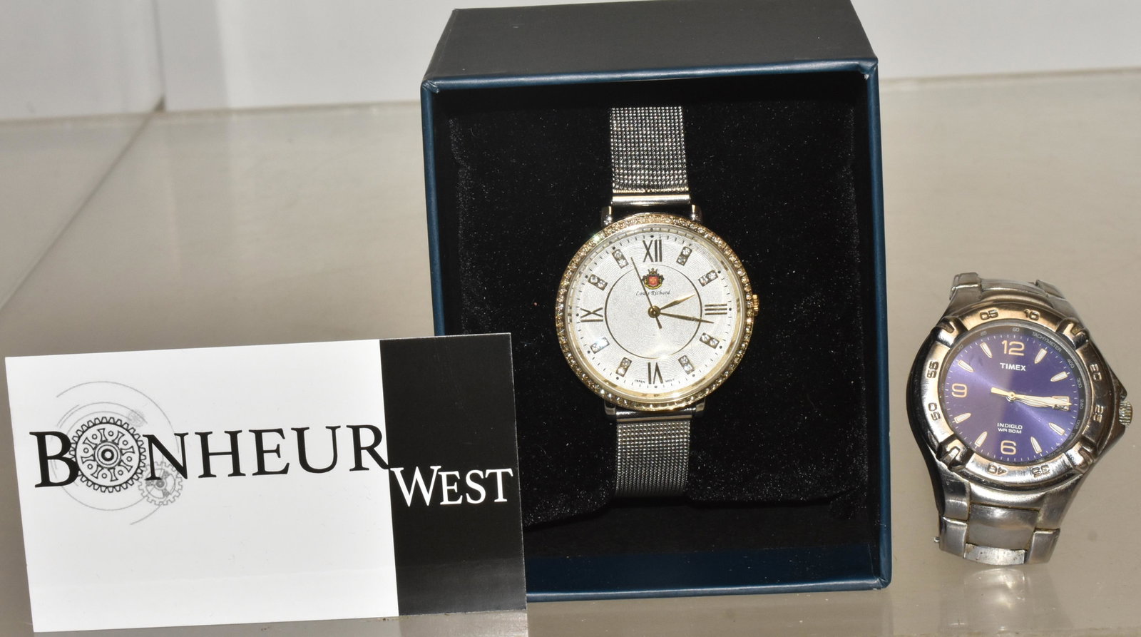 Louis Richard Wristwatch and Another: Lot includes Louis Richard watch in box (currently running), and a Timex Indiglo watch (currently running).