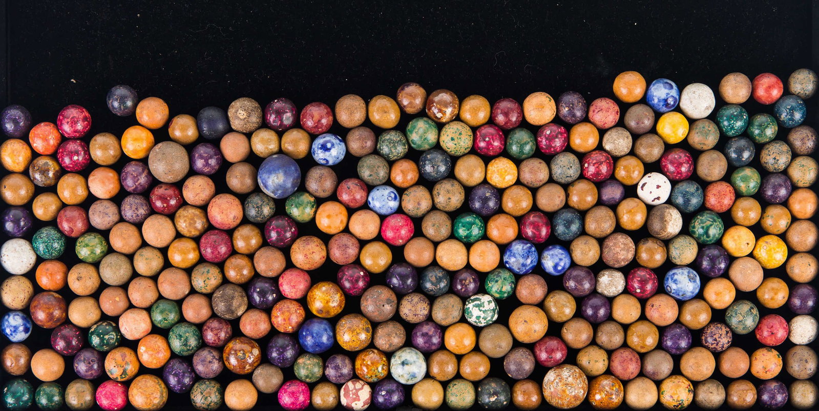 Collection of Clay Marbles: Large collection of clay marbles in various colors.
