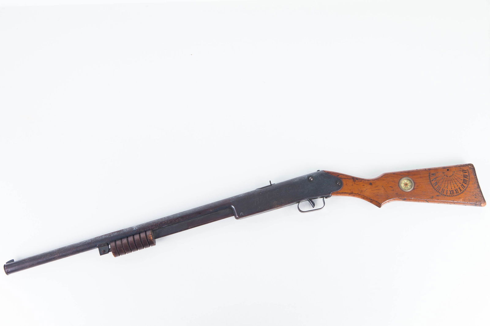 Daisy Buck Jones Air Rifle: Item measures approximately 36"L. It is a pump air gun (pump is stiff but functions) with wooden stock with Daisy compass and sundial (missing arrow). It reads Buck Jones on side. It retains tip with