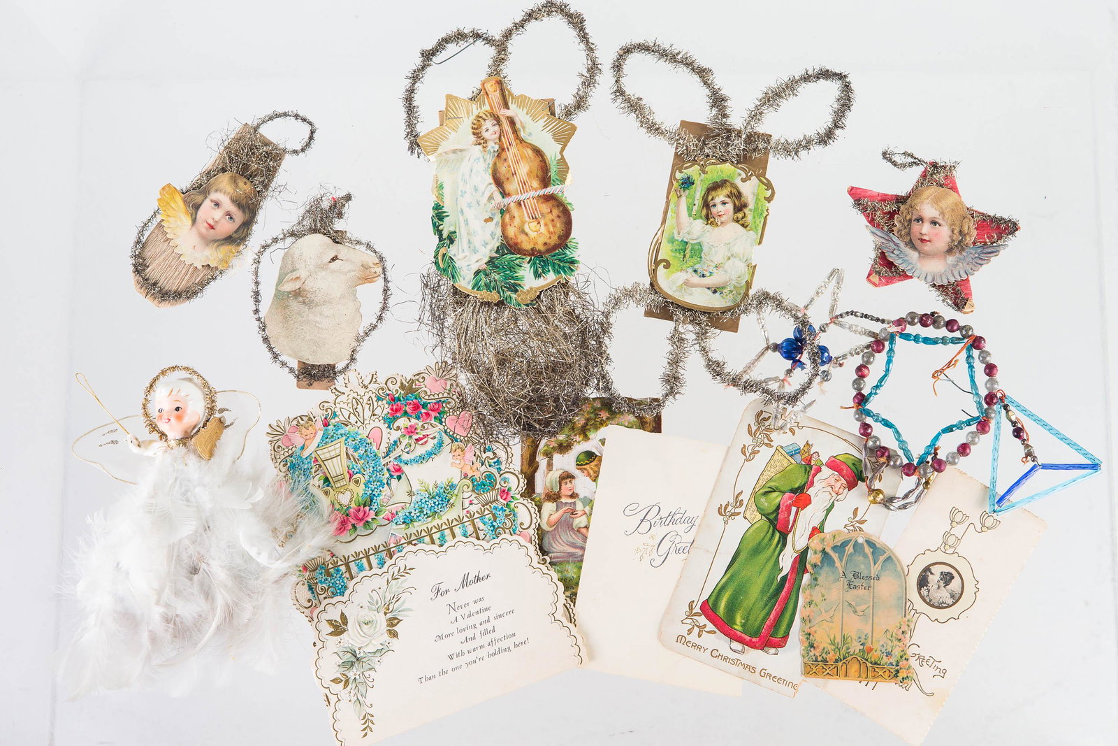 Vintage Wire Art Christmas Ornaments and Related: Lot includes 5 lithograph wire art Christmas ornaments, three glass beaded Christmas ornaments (one needs re-tied), an angel Christmas tree topper with feathers, and six Christmas cards (one is a fold
