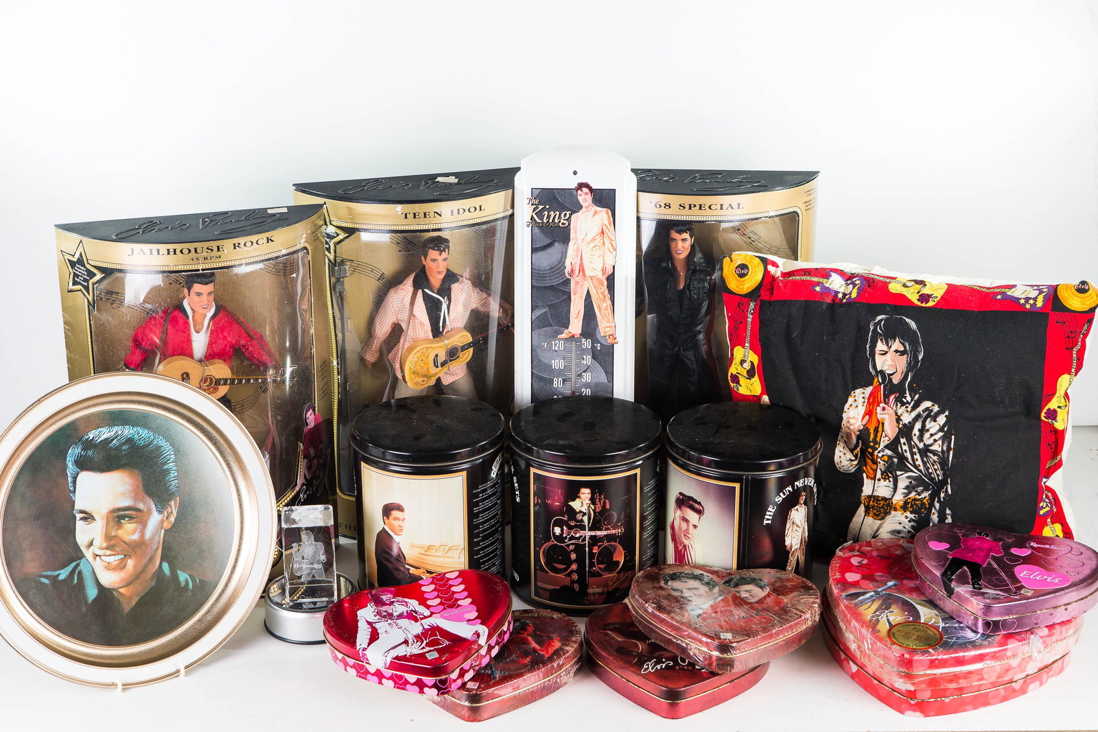 Elvis Dolls and Collectibles: Lot includes 3 Elvis dolls NIB, Elvis thermometer, 3 Elvis tins, an Elvis tray, and glass Elvis paperweight.