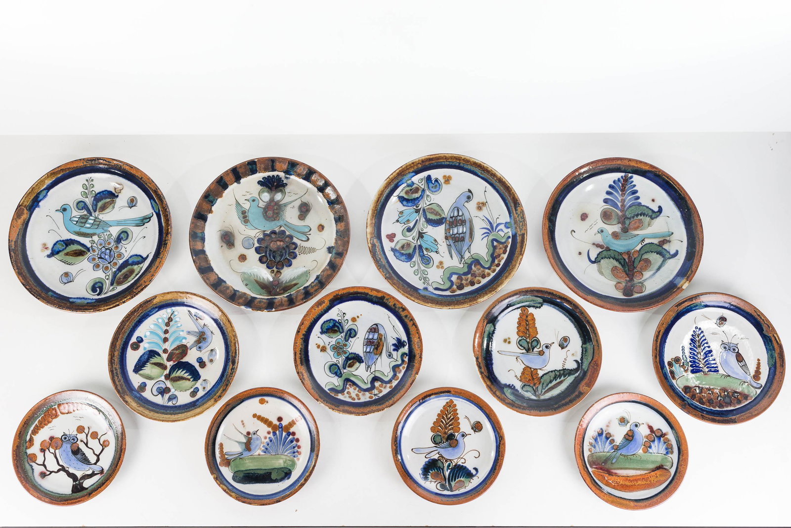 Ken Edwards Mexican Dinnerware: Lot includes 4 10" dinner plates, 4 8" salad plates, and 4 6.75" bread and butter plates. All have bird designs, and are marked "KE, Mexico".