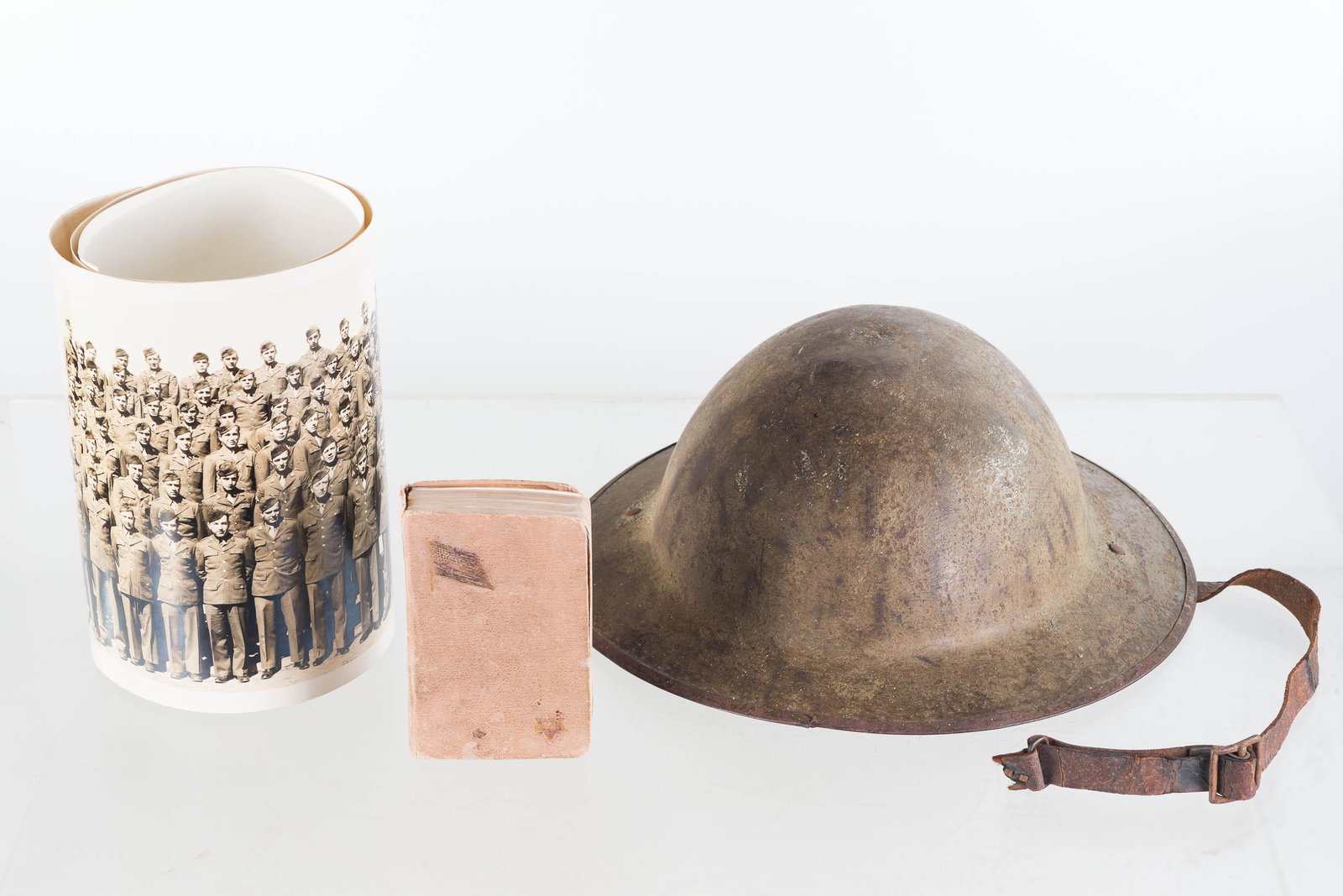 WWII Doughboy Helmet and Related: Lot includes doughboy helmet with partial liner, vintage YMCA Bible, and a yard long military group photo from unknown location.