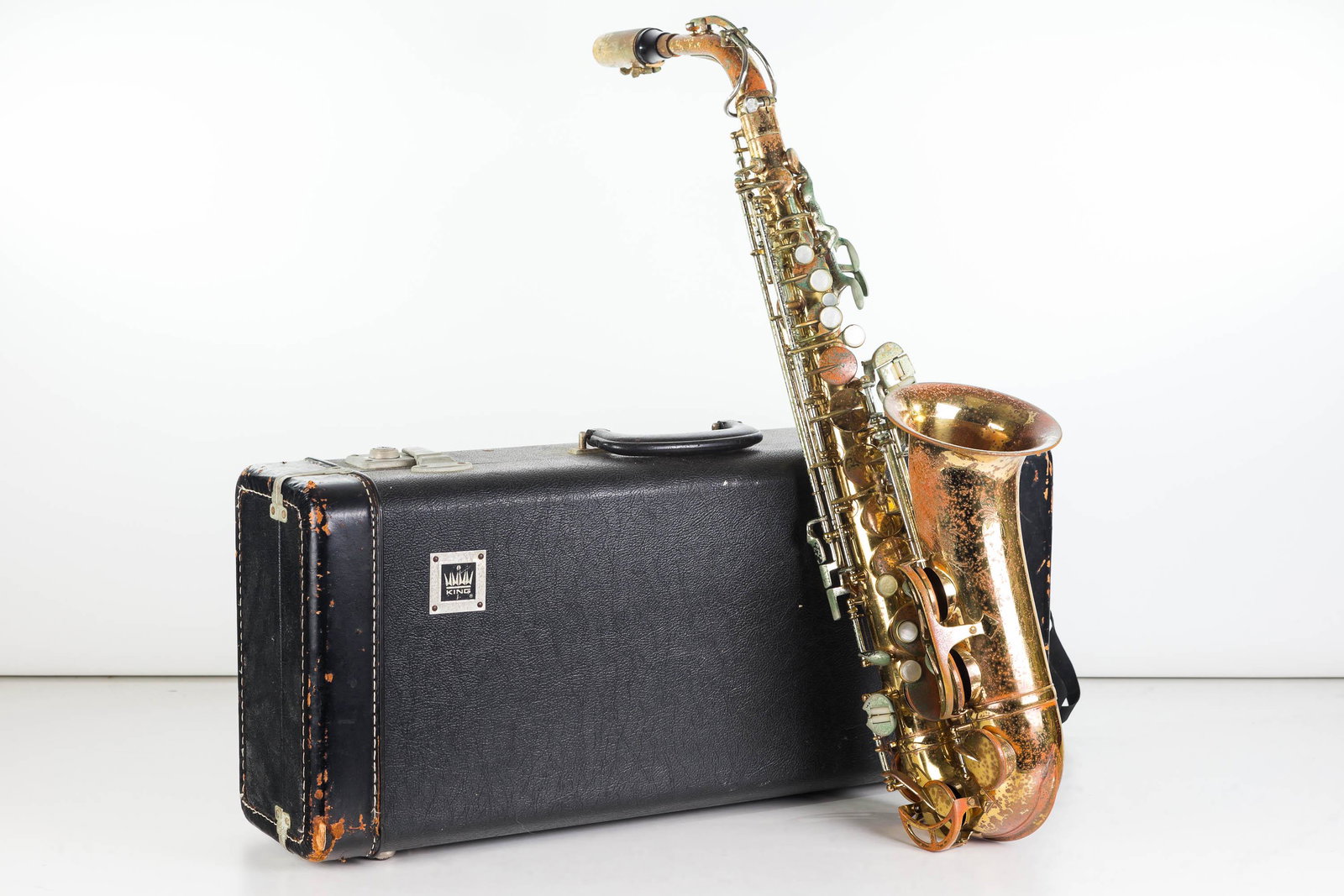 Saxophone, Complete with Case: Item measures approximately 25"L, not including mouth piece. Surface pitting to body, and comes in hard shell case marked King.