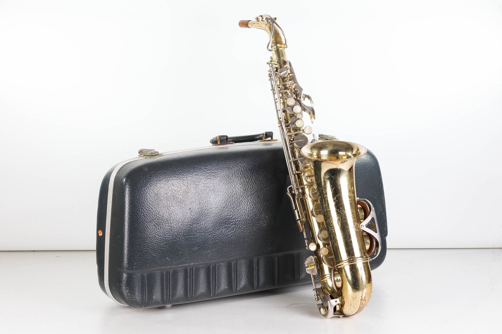 Saxophone in Hard Shell Case: Item measures approximately 24"L not including bend towards mouth piece (mouth piece is missing). Item has surface scratches in body. Comes in hard shell case marked Conn.