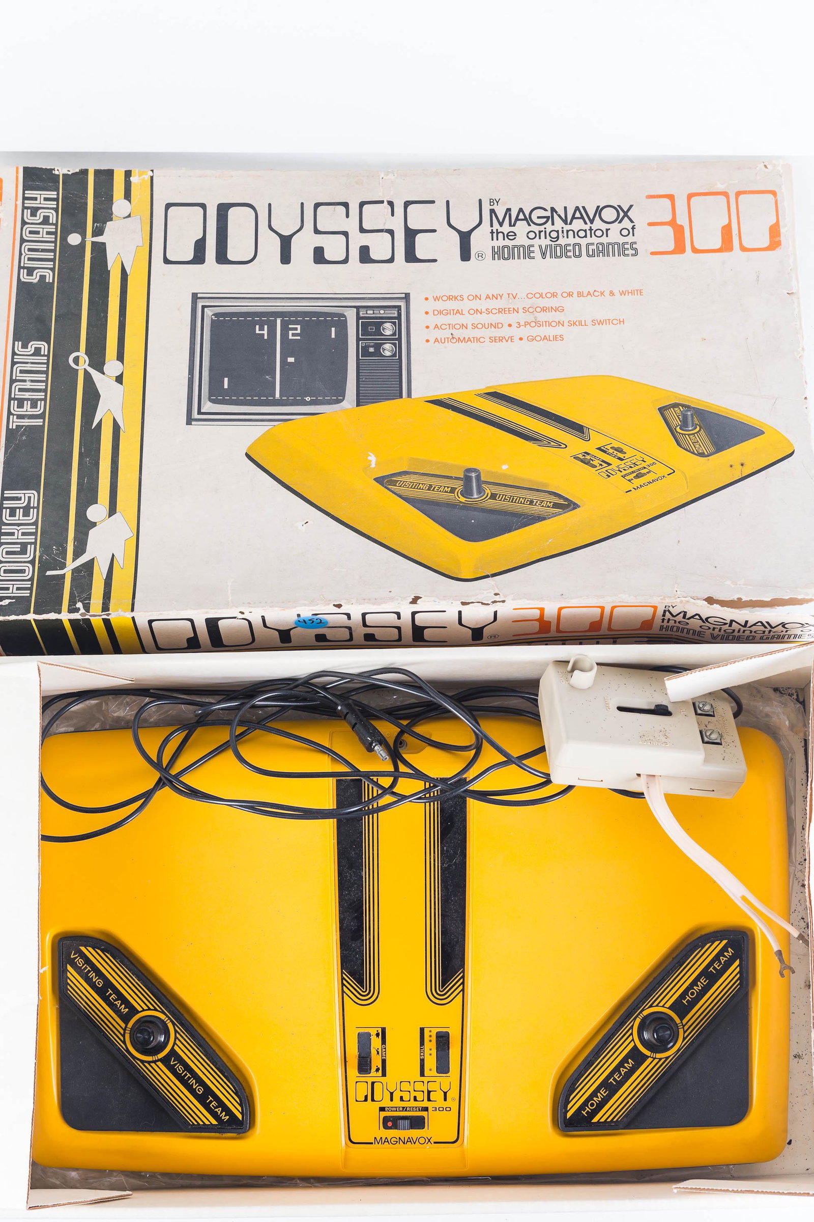 Odyssey 300 Home Video Game: Odyssey game by Magnavox. Box dated 1976. Contents includes Magnavox Odyssey 300 system, with controllers, and electric hookup. Box shows wear, game appears to be clean.