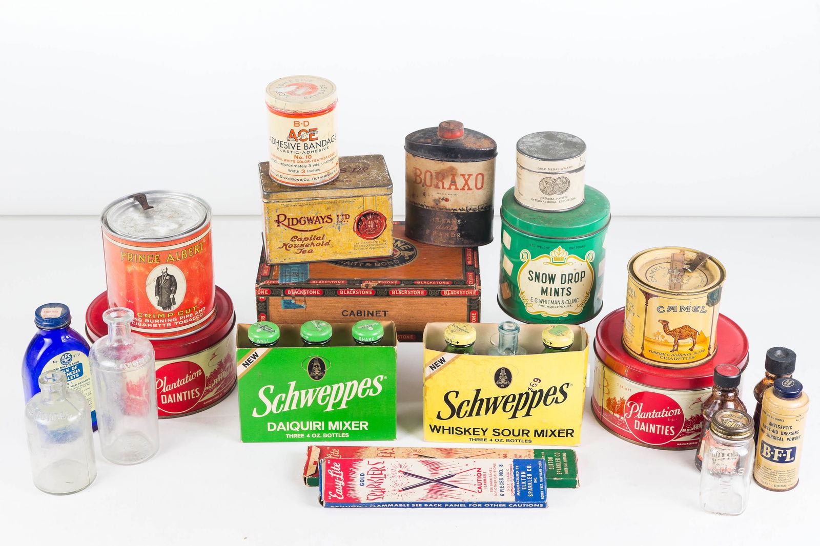 Vintage Advertising Collection: Lot includes Camel and Prince Albert Tobacco tins (Prince Albert's in a can... let him out!), American Beauty Fragrance from Pan Pacific International Expo, Snow Drop Mints, Shanola bottles, Schweppes