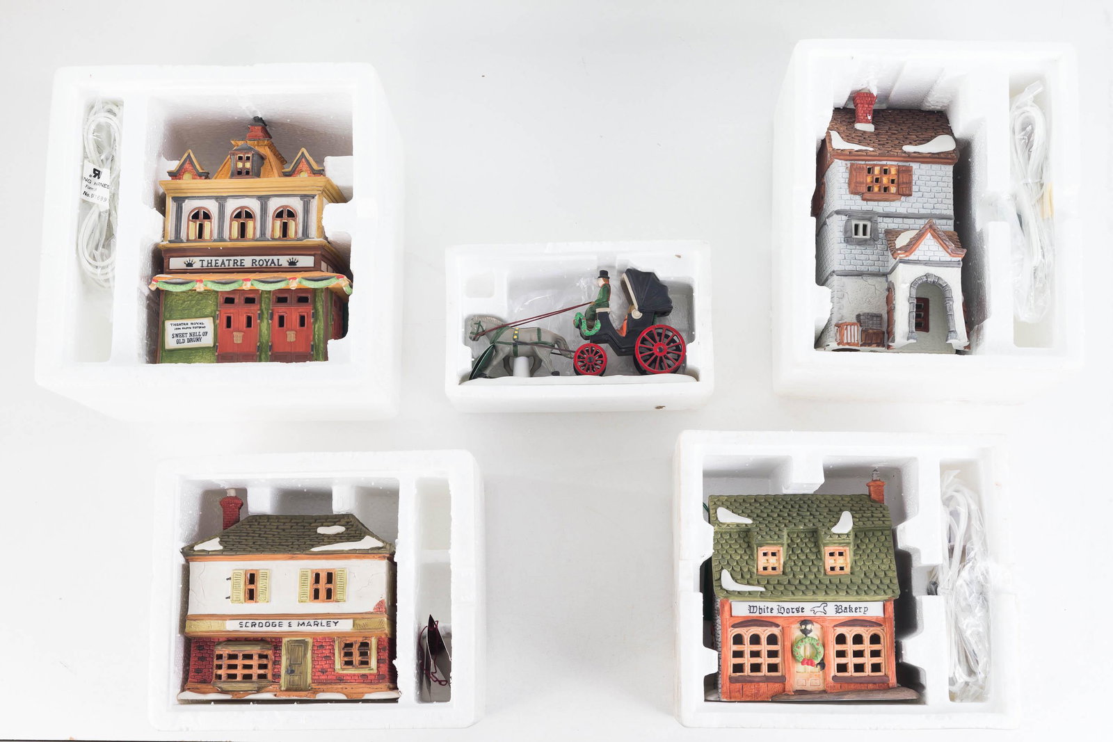 Department 56 Dickens' Village Collection: Lot includes A Christmas Carol 3-piece set, White Horse Bakery, Theater Royale, Poultiere, and Central Park Carriage.