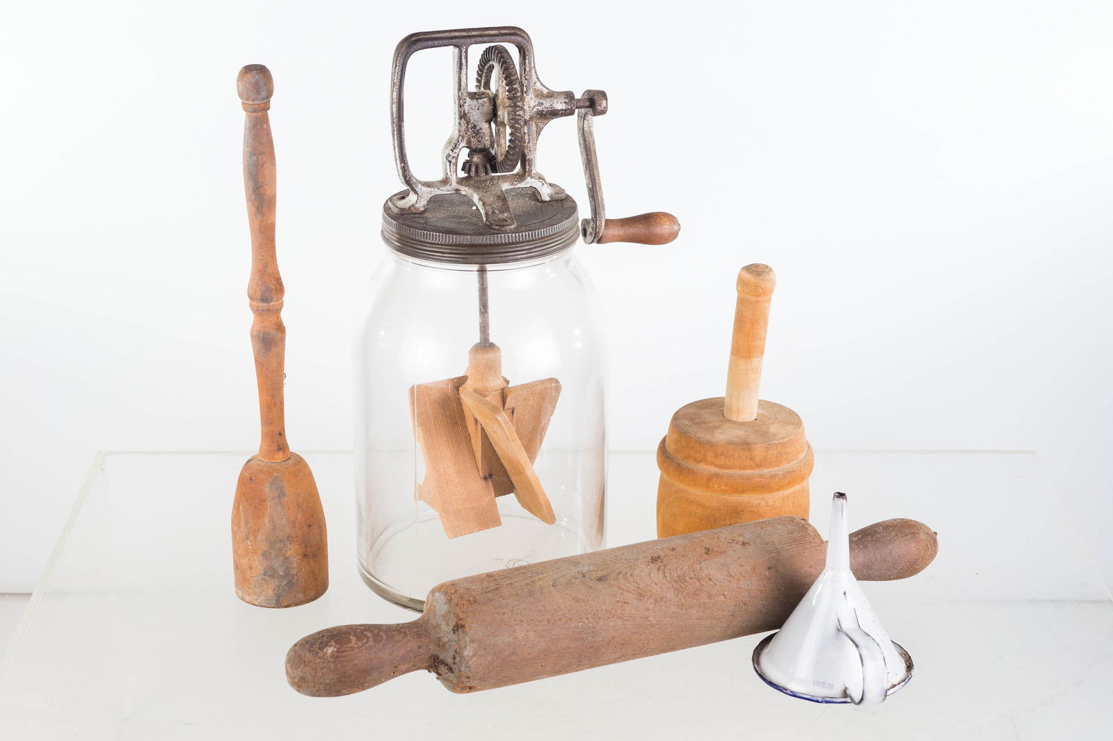 Dazy Style Butter Churn and Treenware: Lot includes unmarked butter churn (14"H) with wooden batter, fully functional. Lot also includes a wooden rolling pin, an enameled funnel, and a later butter print with lamb.