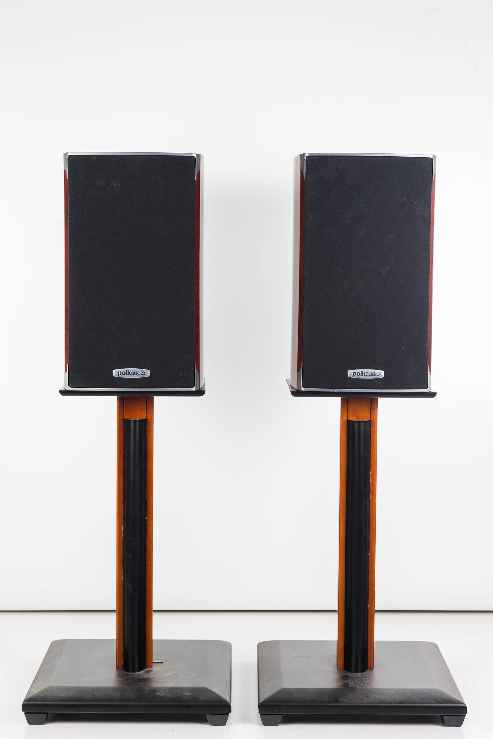 Polk Stereo Speakers and Sanus Stands: Speakers measure approximately 12"H each, and they are Model No. RTI-A1. Lot also includes a pair of Sanus speaker stands measuring approximately 17"H each.