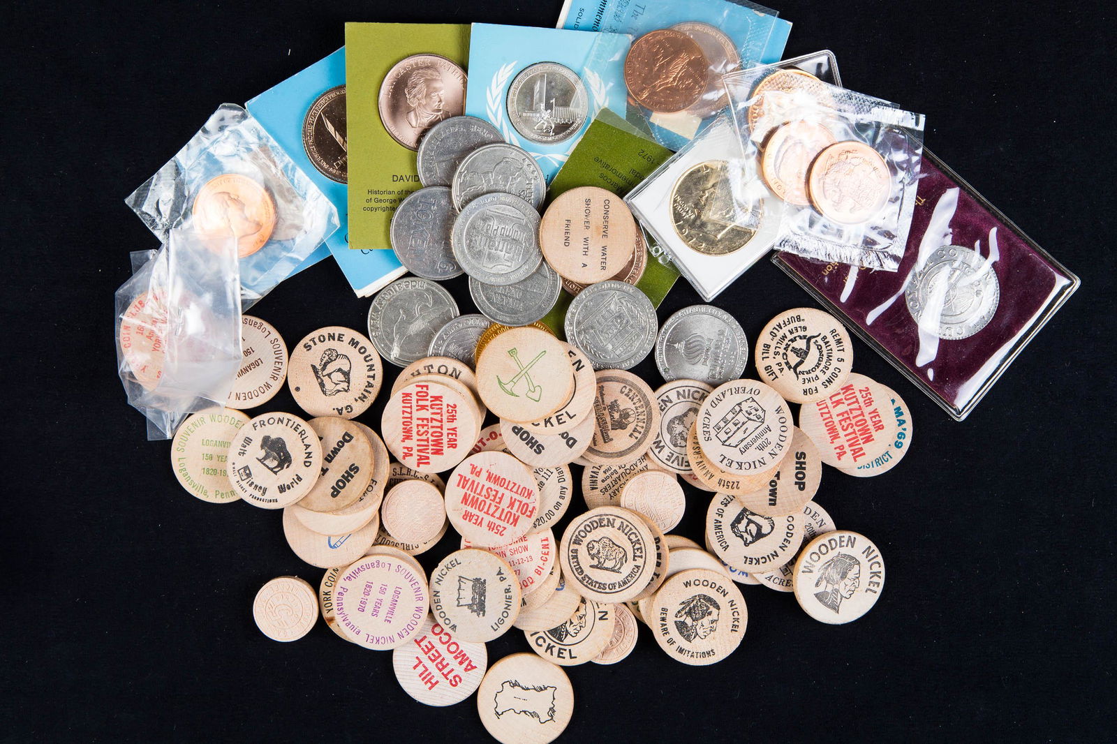 Assorted Tokens, Dollars, and Medals: Lot includes 9 casino tokens, 58 wooden nickels/tokens many from PA, 2 1972 Eisenhower dollars, Presidential tokens including Reagan, and other bronze medals as seen in photos. Includes a sterling sil