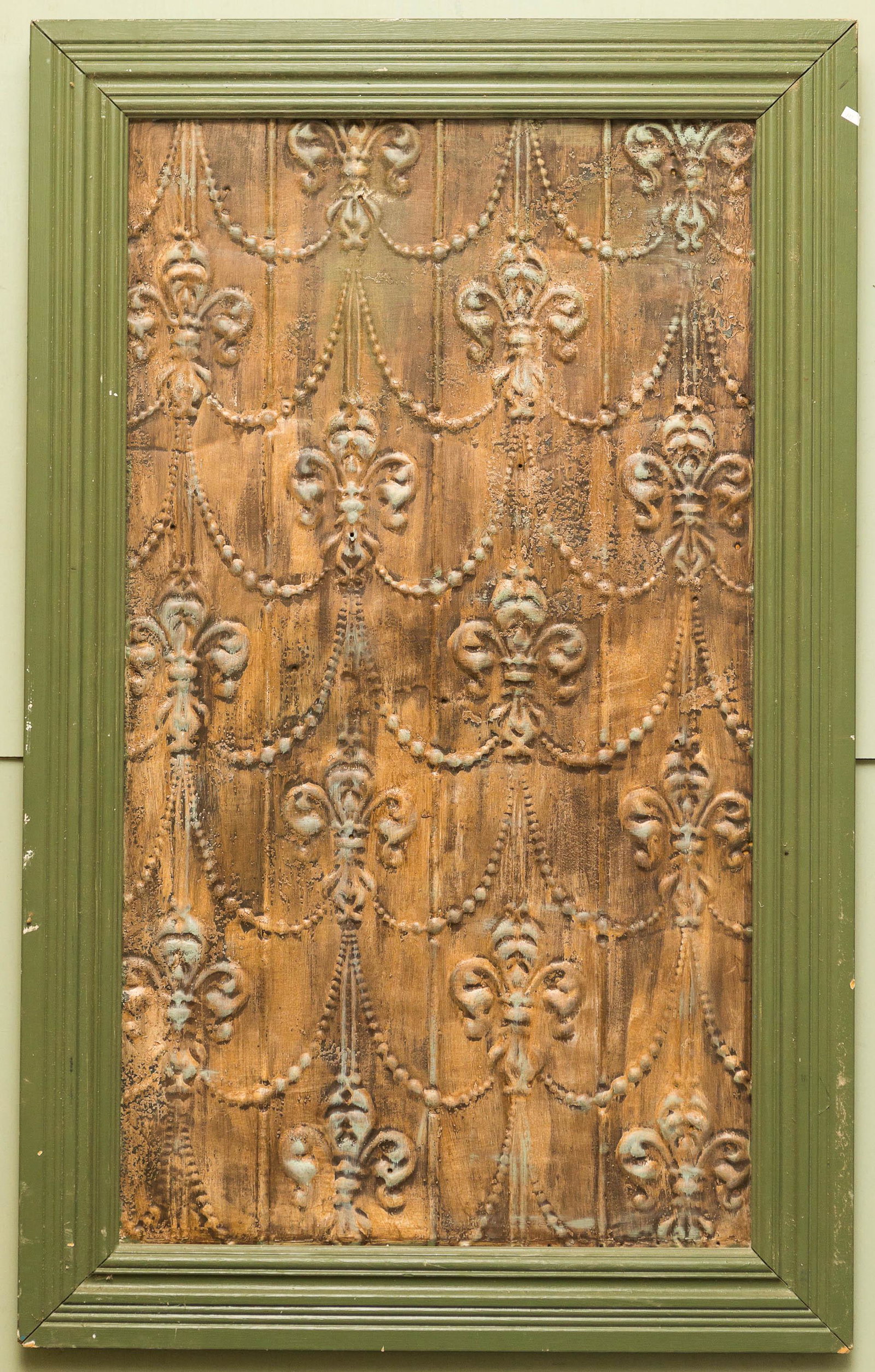 Framed Tin Architectural Panel: Pressed tin fleur de lis architectural panel with applied wooden backing in frame measuring approximately 47"H x 29.5"W.