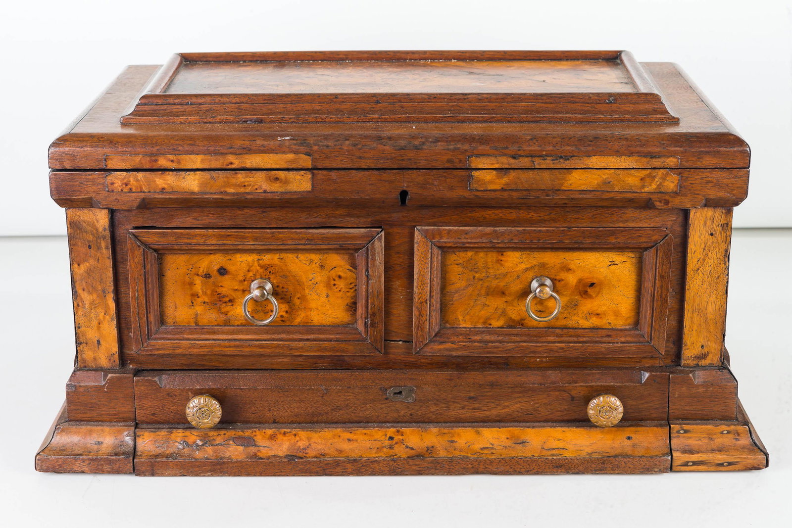 Tabletop Storage Chest, 19th C: Item measures approximately 10"H x 20"W x 12"D at base. Lift top lid, with two drawers that are dovetailed at front and nailed at back, and a base drawer with felt lining. Mixed wood construction with